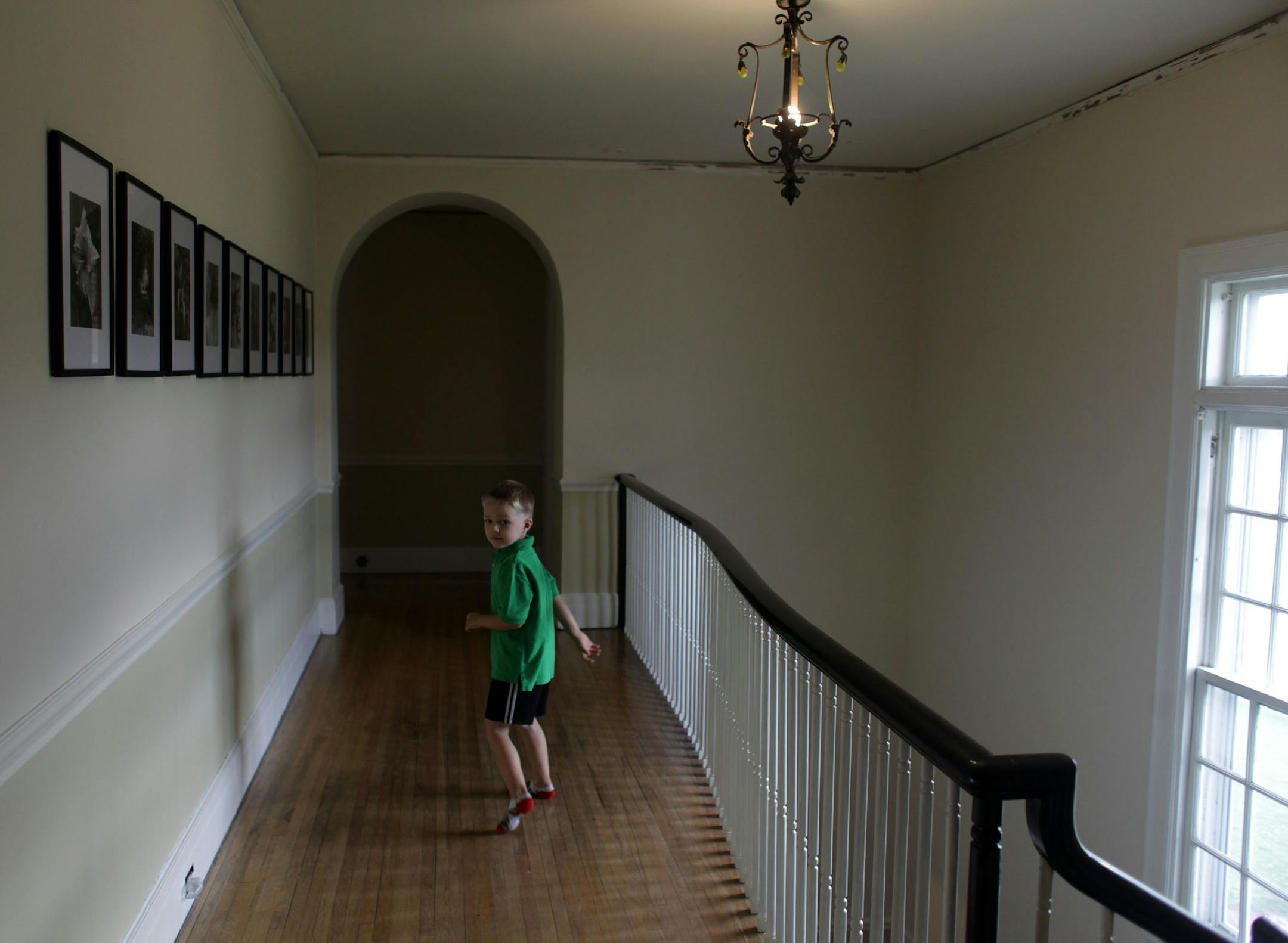 Lucian Pier, 4, runs through the second floor hallway at his home on Thursday afternoon. ] Architect/homeowner Alissa Pier used original 1920s blueprints to restore this home in north Minneapolis, after a tornado tore off its roof. MONICA HERNDON monica.herndon@startribune.com Minneapolis, MN 07/24/14
