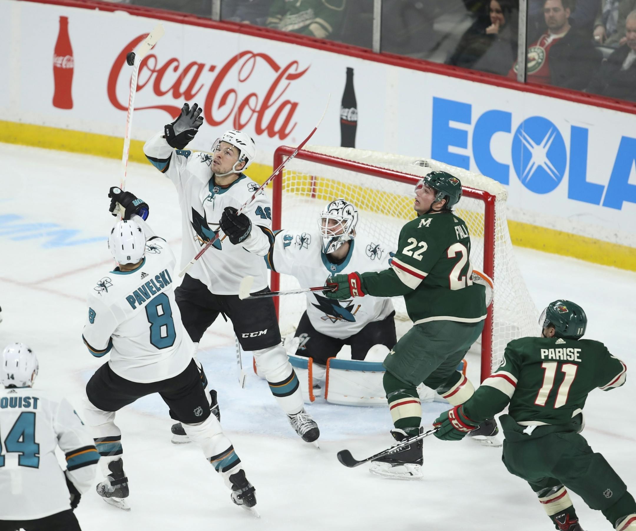 San Jose Sharks center Joe Pavelski (8) knocked a puck to the ice before his teammate center Tomas Hertl (48) could glove it in front of Sharks goaltender Martin Jones and Minnesota Wild left wing Kevin Fiala (22) in the third period.