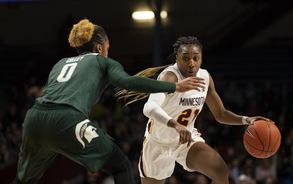 Minnesota Golden Gophers guard Jasmine Brunson (21) made a move on Michigan State Spartans guard Shay Colley (0) while driving to the hoop in the four