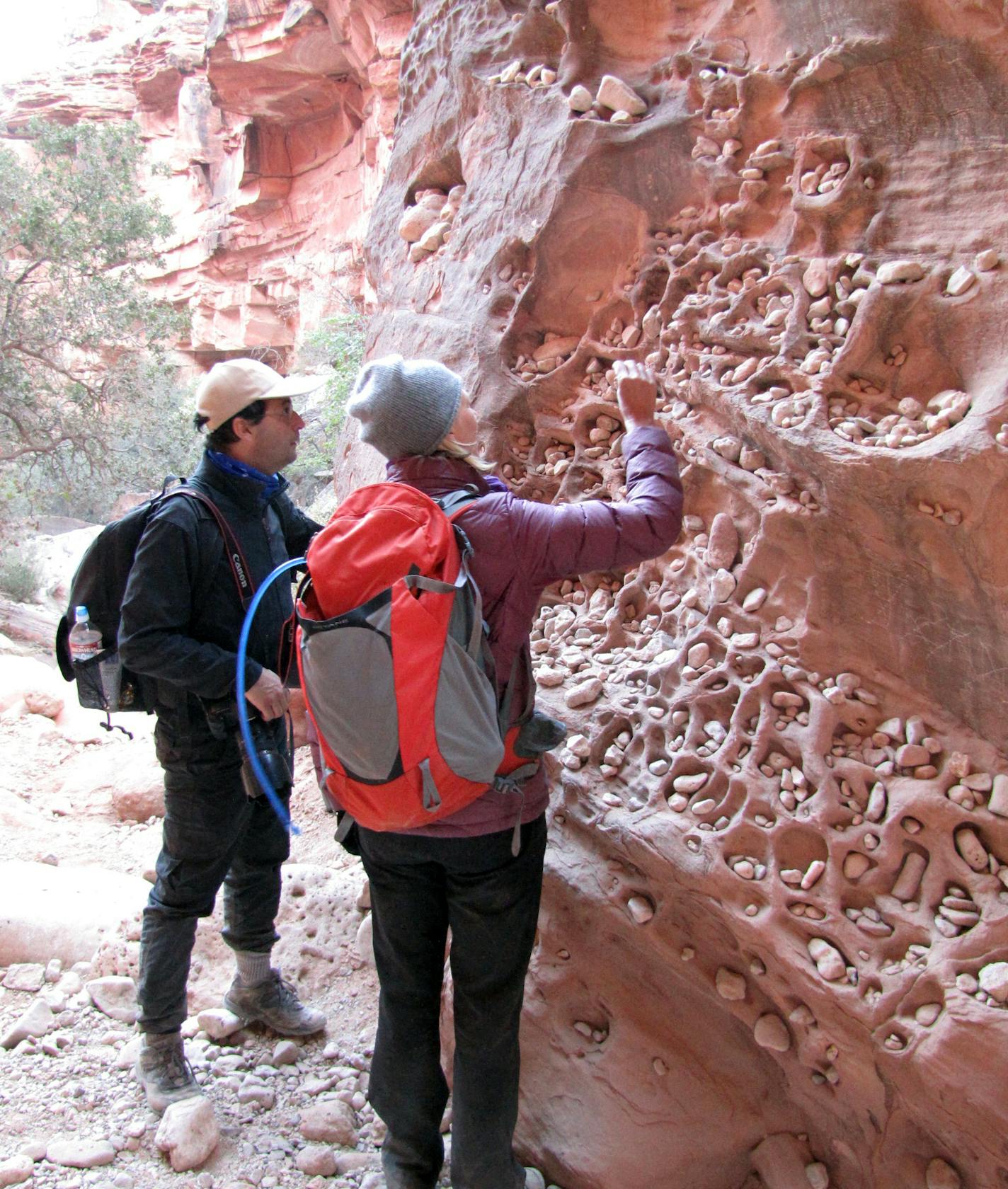 Two hikers places stones in Time Clock Rock. AOA Adventures guides say to &#x201a;&#xc4;&#xfa;punch in&#x201a;&#xc4;&#xf9; on your hike to Supai, making a wish and placing a rock in one of the niches. On the hike out, if you remember to &#x201a;&#xc4;&#xfa;punch out&#x201a;&#xc4;&#xf9; and remove your rock, your wish will come true. Photo by Melanie Radzicki McManus.