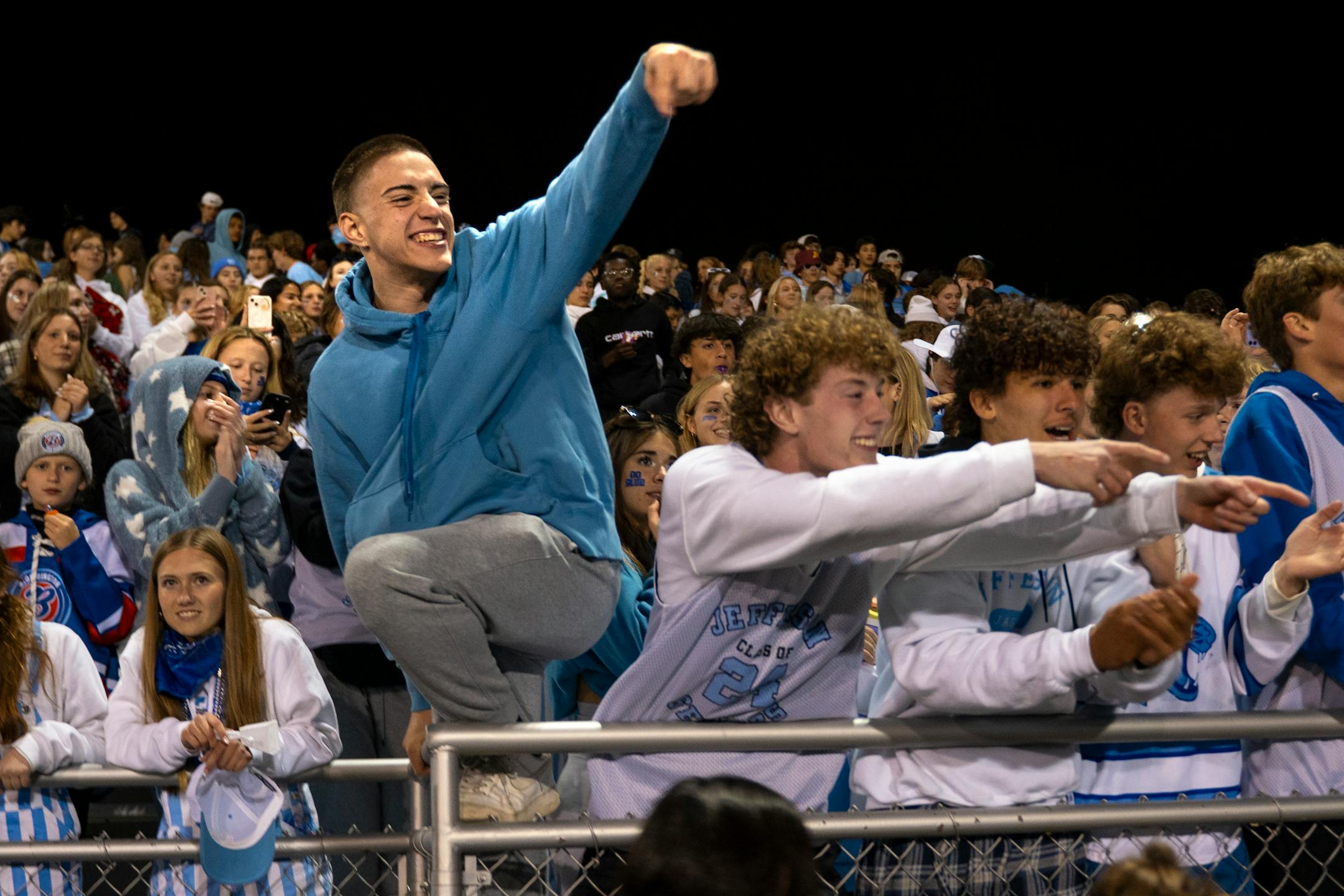 Students and fans cheer for the Bloomington Jefferson Jaguars after their win against Robbinsdale Cooper.