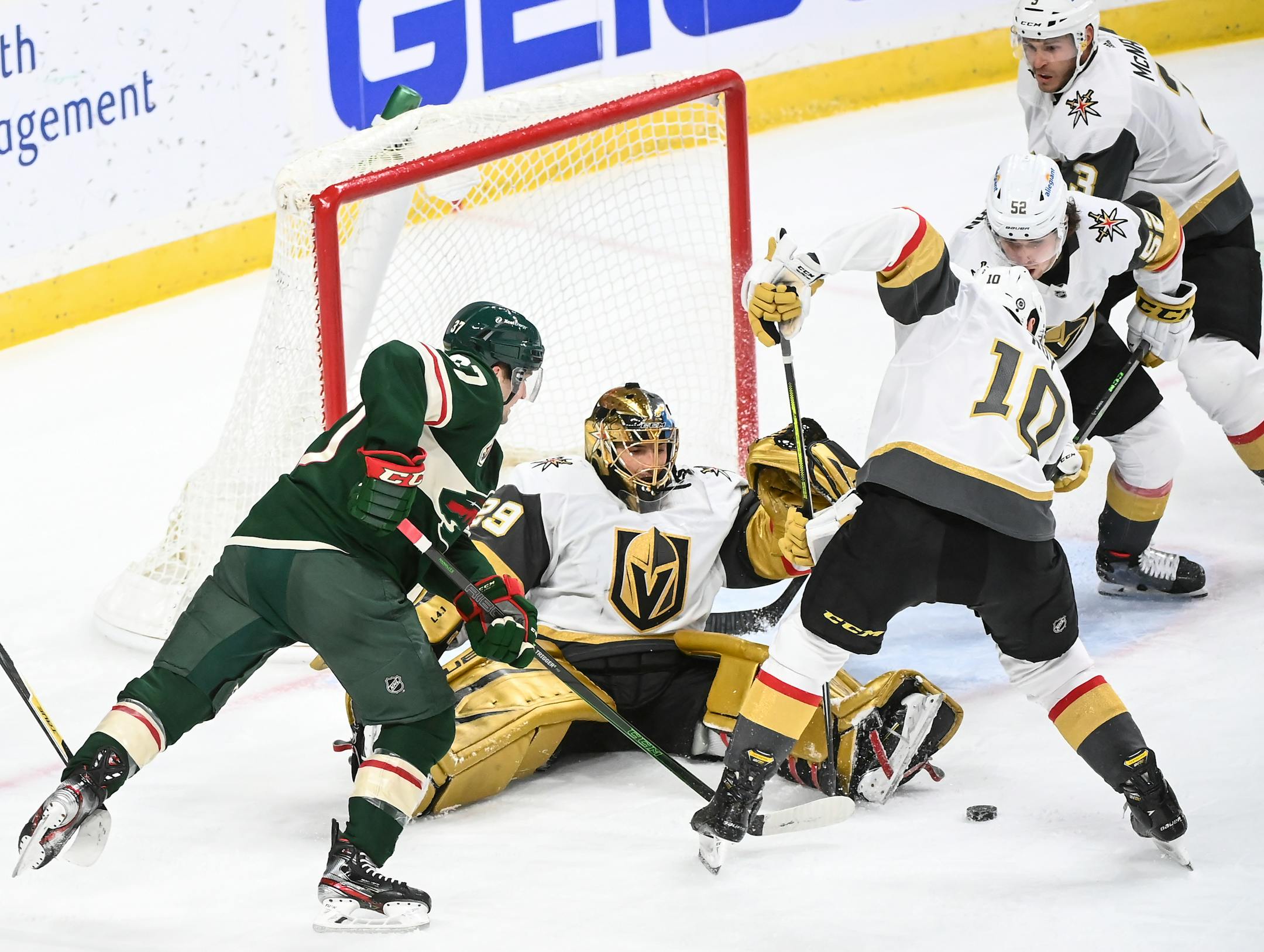 Vegas Golden Knights goaltender Marc-Andre Fleury (29) made a save as Minnesota Wild center Kyle Rau (37) attacked the goal in the third period.