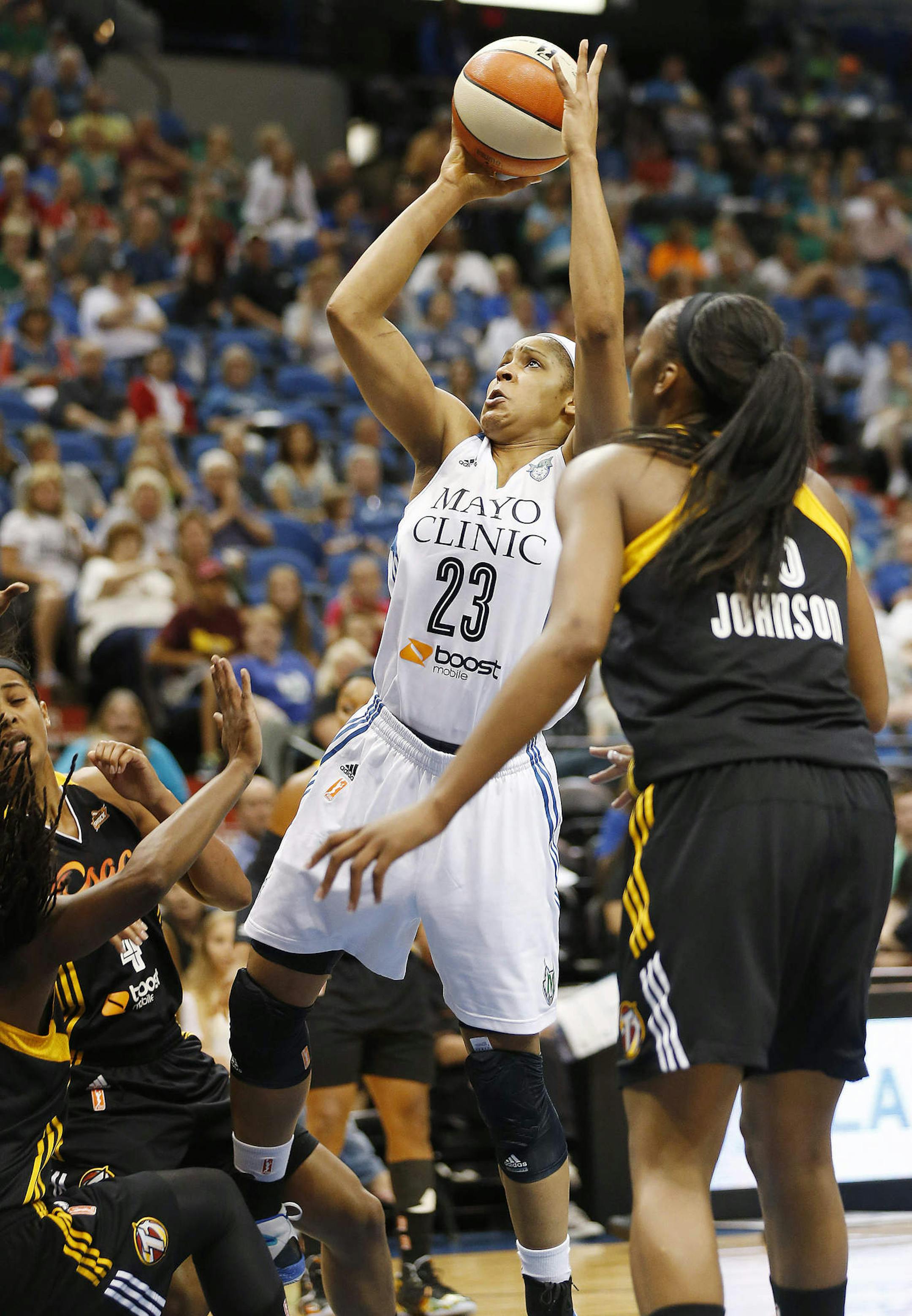 Minnesota Lynx forward Maya Moore (23) looks to shoot past Tulsa Shock forward Glory Johnson (25) during the first half of a WNBA basketball game, Wednesday, July 16, 2014, in Minneapolis. (AP Photo/Stacy Bengs)