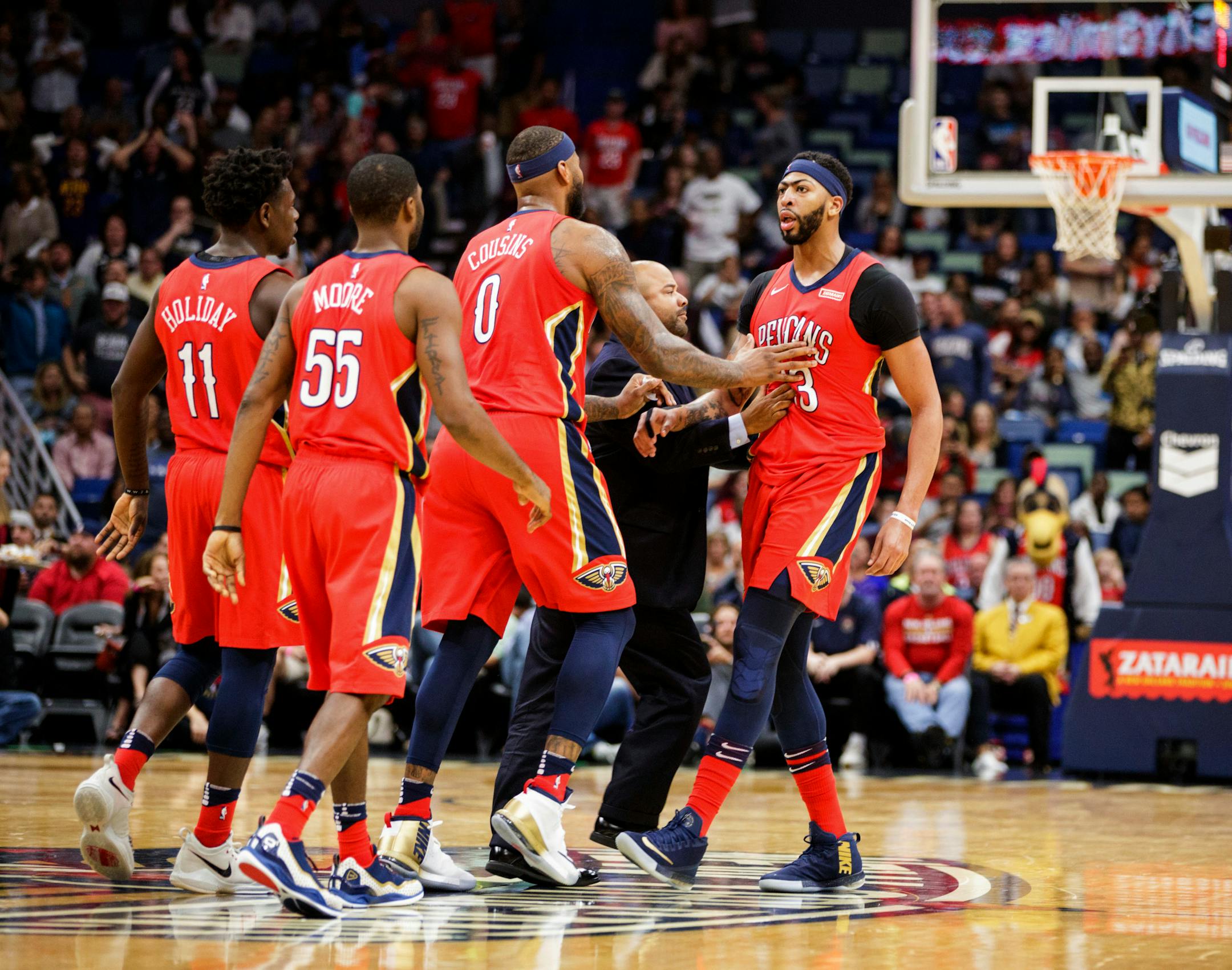 New Orleans Pelicans' DeMarcus Cousins (0) and teammates try to calm down Anthony Davis (23) as he is ejected for his second technical foul during the team's NBA basketball game against the Minnesota Timberwolves in New Orleans, Wednesday, Nov. 29, 2017. (Sophia Germer/The Advocate via AP)