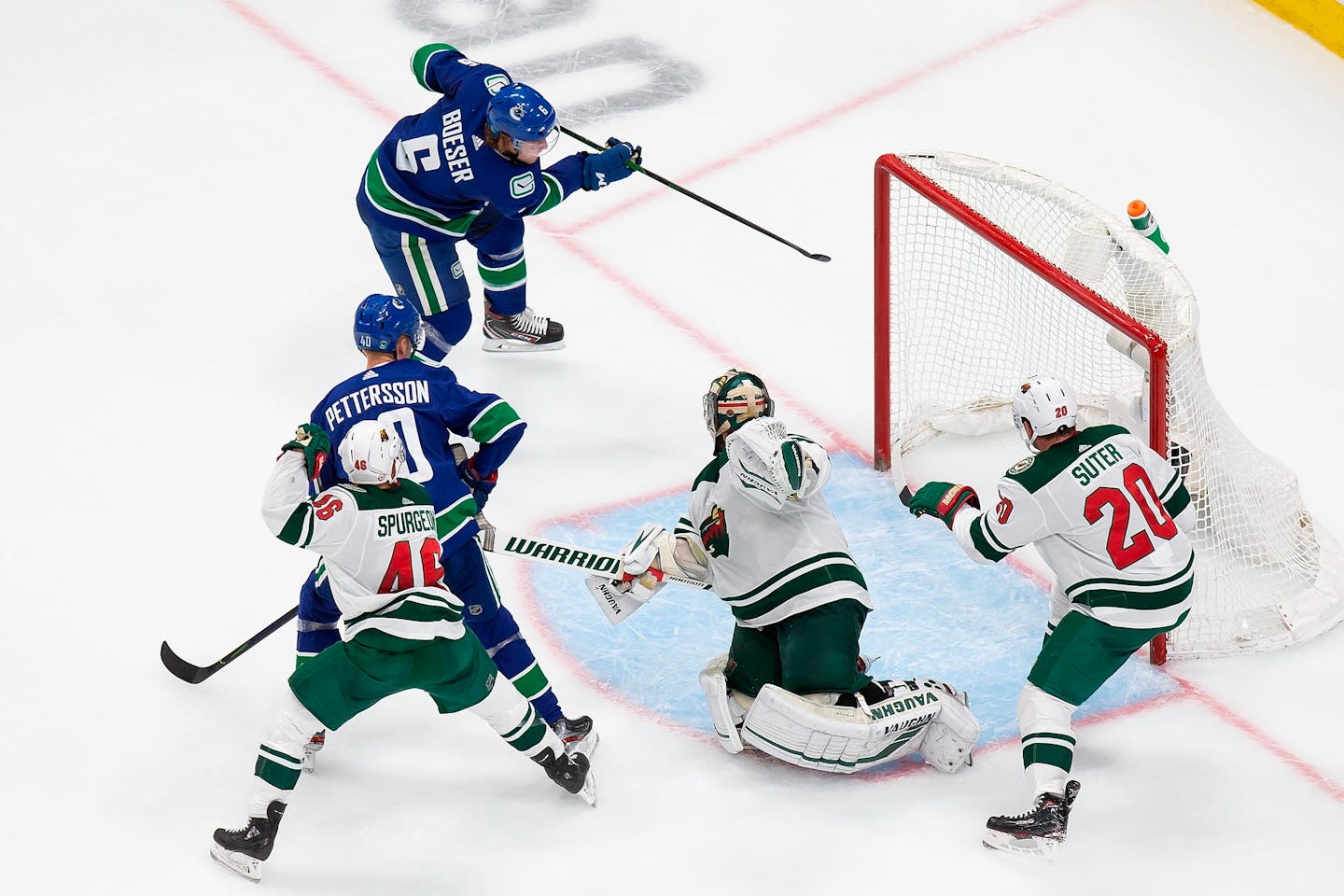 Wild goaltender Alex Stalock can't stop Vancouver's Brock Boeser from scoring during the second period.