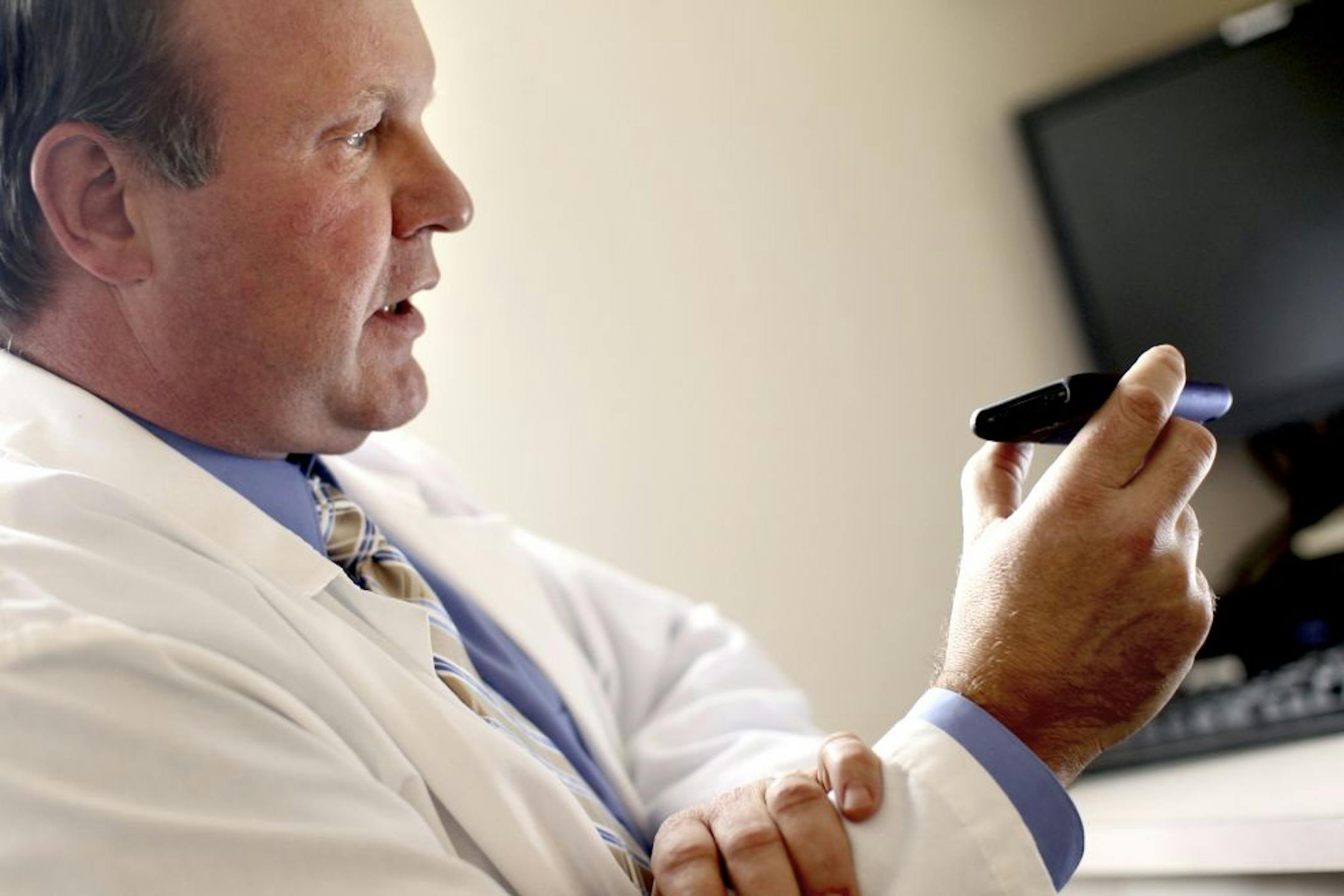 Dr. Douglas Smith, Chief Medical Officer for Consult A Doctor, demonstrates a phone consultation with one of his patients at his office in Plymouth February 3, 2012. Consult A Doctor seeks to increase the use of telemedicine as an adjunct, not as a replacement, for in-person doctor visits.