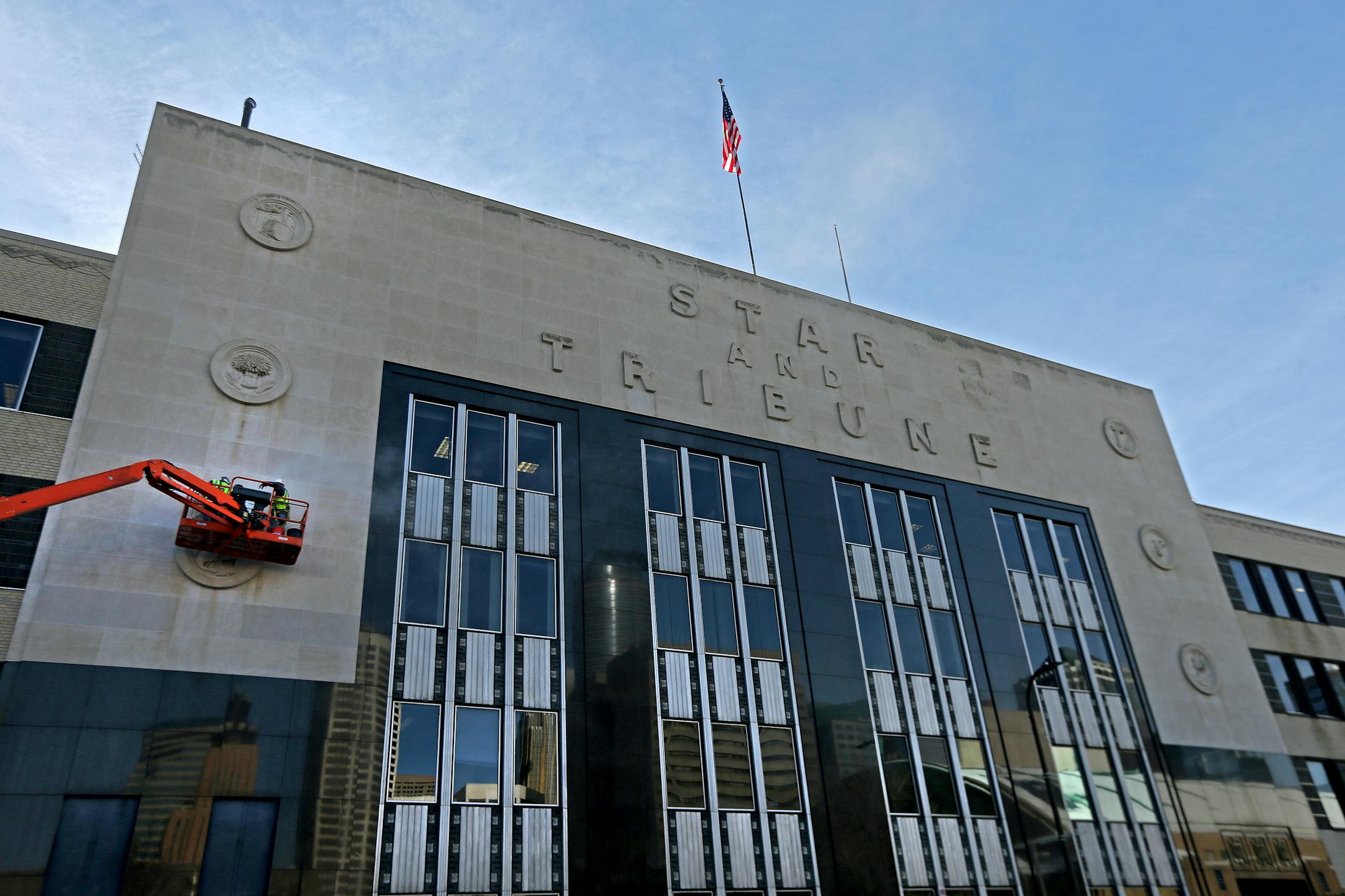 A construction crew from Ryan began the process of removing medallions from the front of the Star Tribune building, Monday, Feb. 10.