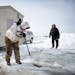 Dave Kuntz of Waconia chipped his wood supports out of the ice after removing his ice fishing house.