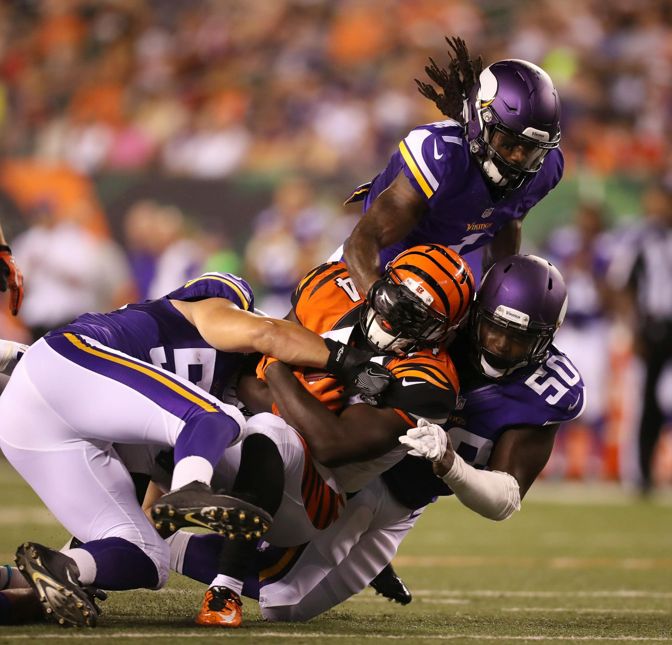 During a third quarter punt return, Cincinnati Bengals running back Bronson Hill (34) was brought down by the combined efforts of the Vikings' Jake Ganus (56), Troy Stoudermire (1), and Terrance Plummer (50) Friday night in Cincinnati. ] JEFF WHEELER � jeff.wheeler@startribune.com The Minnesota Vikings eked out a 17-16 win over the Cincinnati Bengals in their first game of the NFL preseason Friday night, August 12, 2016 at Paul Brown Stadium in Cincinnati, OH.