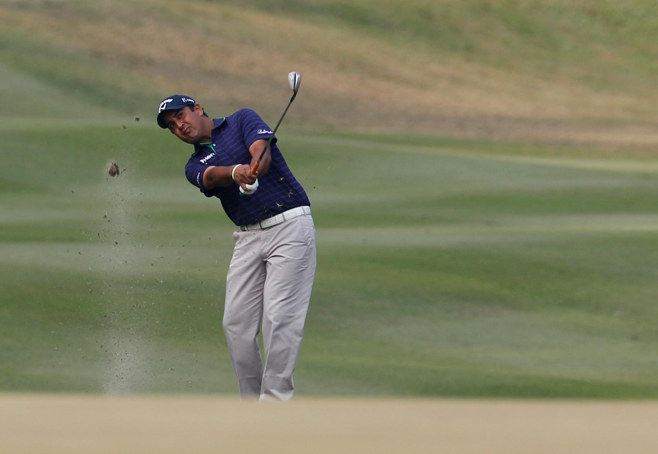 Shiv Kapur of India hits the ball on the 13th hole during the third round of the Hong Kong Open golf tournament in Hong Kong, Saturday, Dec. 7, 2013. (AP Photo/Kin Cheung)