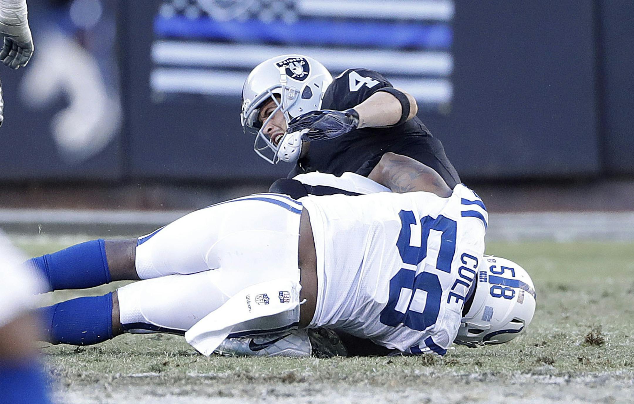 Oakland Raiders quarterback Derek Carr is tackled by Indianapolis Colts outside linebacker Trent Cole (58) during the second half of an NFL football game in Oakland, Calif., Saturday, Dec. 24, 2016. Carr left the game after this play with an injury. (AP Photo/Marcio Jose Sanchez)