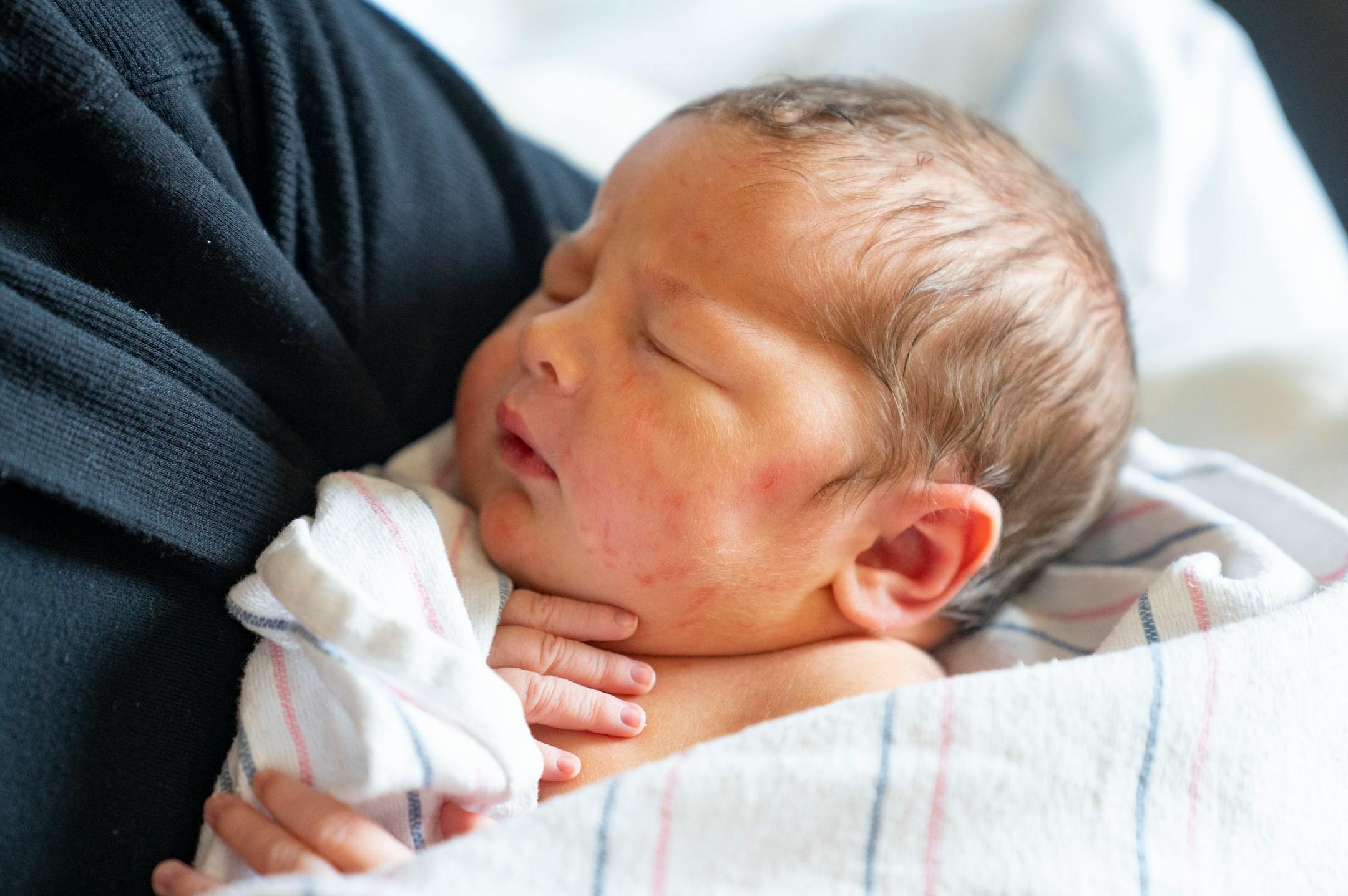 Emily McDonagh holds her newborn daughter, Clare, Thursday, March 24, 2022 at Maple Grove Hospital in Maple Grove, Minn. Clare was born March 23, 2022. The couple has had all three of their children at the hospital over the years.