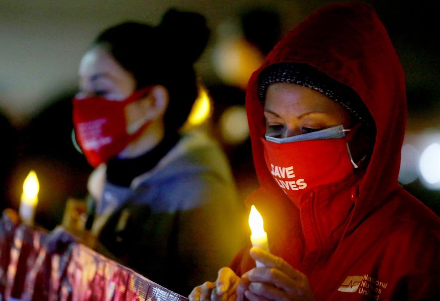 Registered nurses at UCLA Medical Center hold a nighttime vigil on Monday, Nov. 23, 2020, to alert the public about patient safety concerns as COVID-19 hospitalizations spike across the county. The nurses allege short staffing, lack of COVID-19 testing, and exposure notification delays. They urged the public to stay home for the holidays to prevent a further surge the virus.