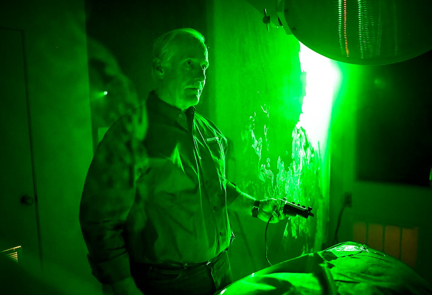 Dr. Scott Augustine gave a demonstration, using a fog machine and a Bair Hugger device, to show the upward flow of air caused by the device which he says contaminates the operating table. He uses a laser to reveal the rising air pattern.