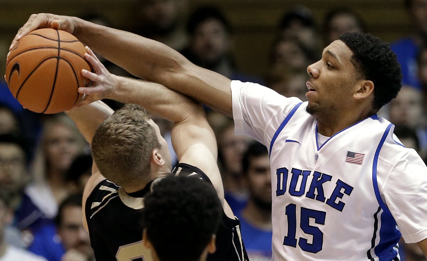 Duke's Jahlil Okafor (15) blocks Army's Kyle Wilson during the first half of an NCAA college basketball game in Durham, N.C., Sunday, Nov. 30, 2014. (AP Photo/Gerry Broome) ORG XMIT: NCGB101