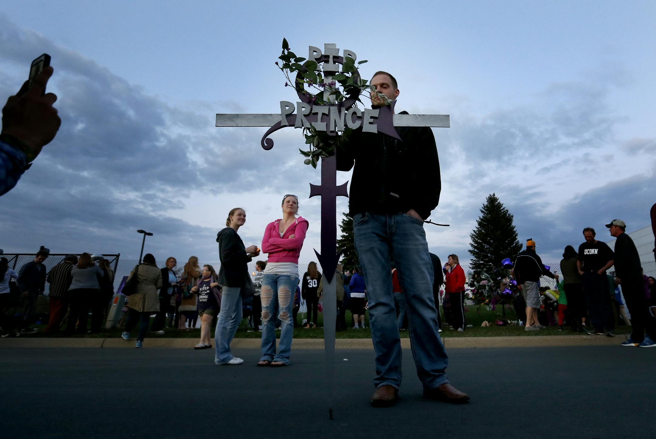 Adam Klostermeier, 28, of Maple Grove posed for photos with a Prince tribute that he built earlier in the day. Musician Prince was found dead at the site on Thursday morning at Paisley Park Studios in Chanhassen, MN.