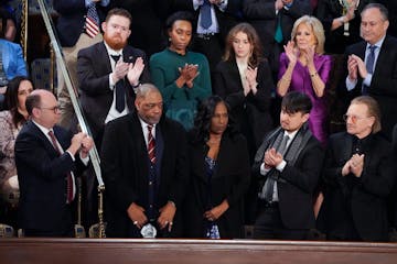 RowVaughn Wells, center, mother of Tyre Nichols, who died after being beaten by Memphis police officers, and her husband Rodney Wells, second left, ar