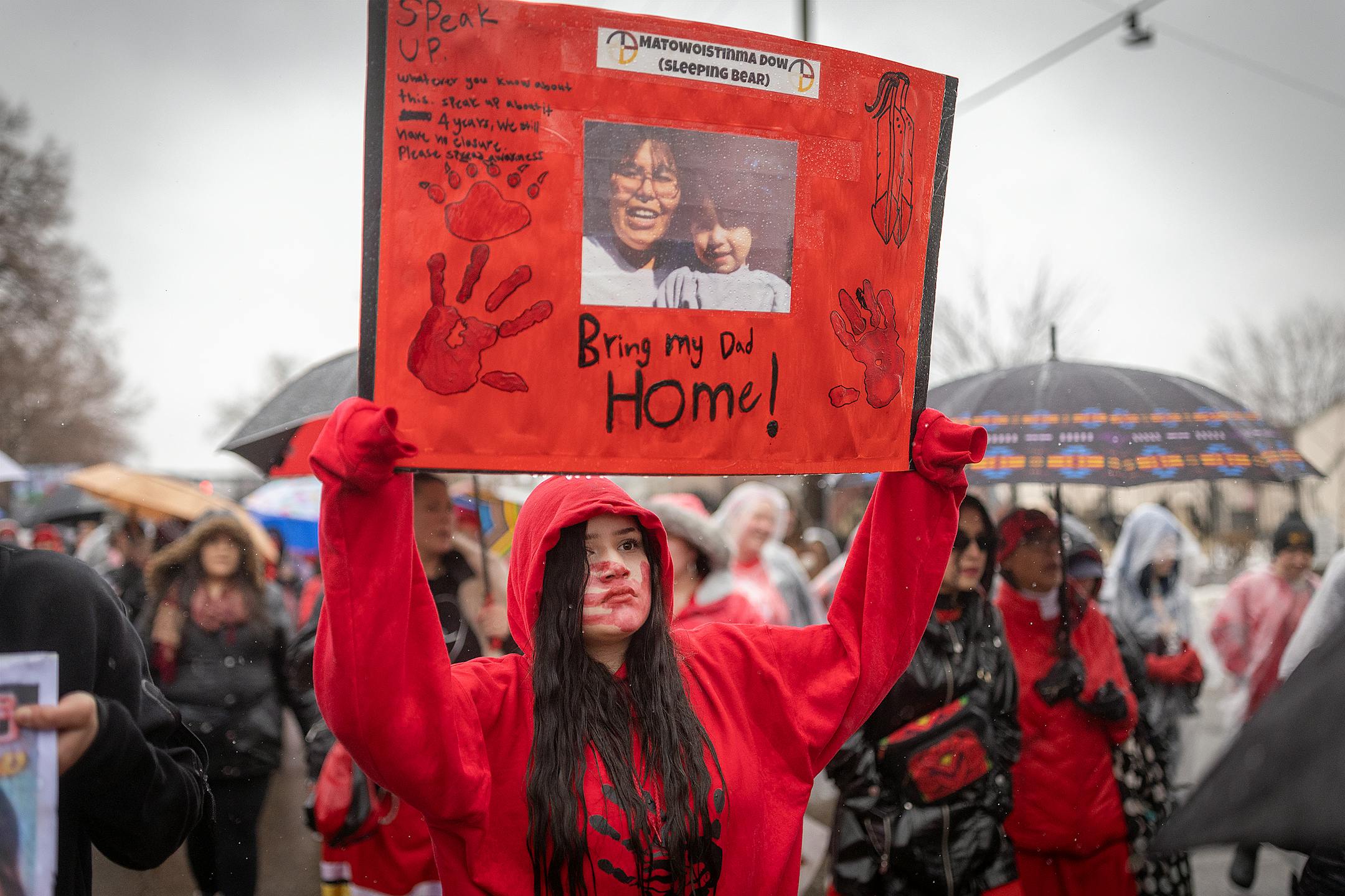 Shankar Dow, 15, cq, holds up a photo of her father, who went missing five years ago, as she joined hundreds during the annual Missing and Murdered Indigenous Women's rally and march at the East Phillips Park Cultural & Community Center, in Minneapolis, Minn., on Tuesday, Feb. 14, 2023.  Minnesota's movement to solve the cases of hundreds of missing and murdered Indigenous women and girls hit a milestone last year with the opening of a first-in-the-nation office tasked with systemically trying to fix the problem. Minnesota's Native women legislators reflected on where the movement goes from here during the annual Missing and Murdered Indigenous Women's march in Minneapolis.   ] Elizabeth Flores • liz.flores@startribune.com