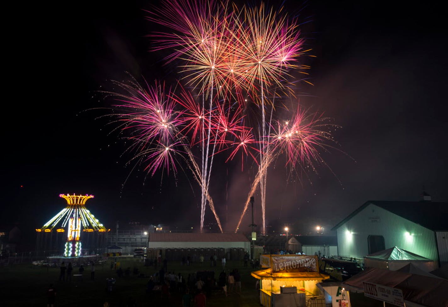 Fireworks explode over the Carver County Fairgrounds as part of the Taste of Minnesota celebration in Waconia on Thursday, July 2, 2015.