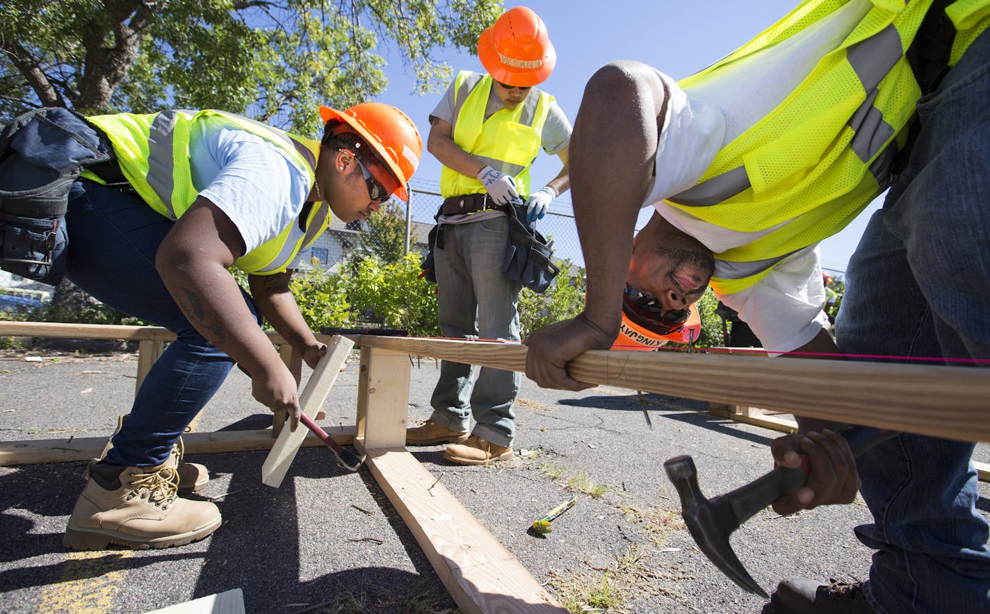 Jazmine Hawkins, left, worked with Victoria Moorhead and Jason Coleman on a construction class project at Summit Academy OIC. Hawkins is looking to herself to challenge the trend when it comes to minority household incomes.