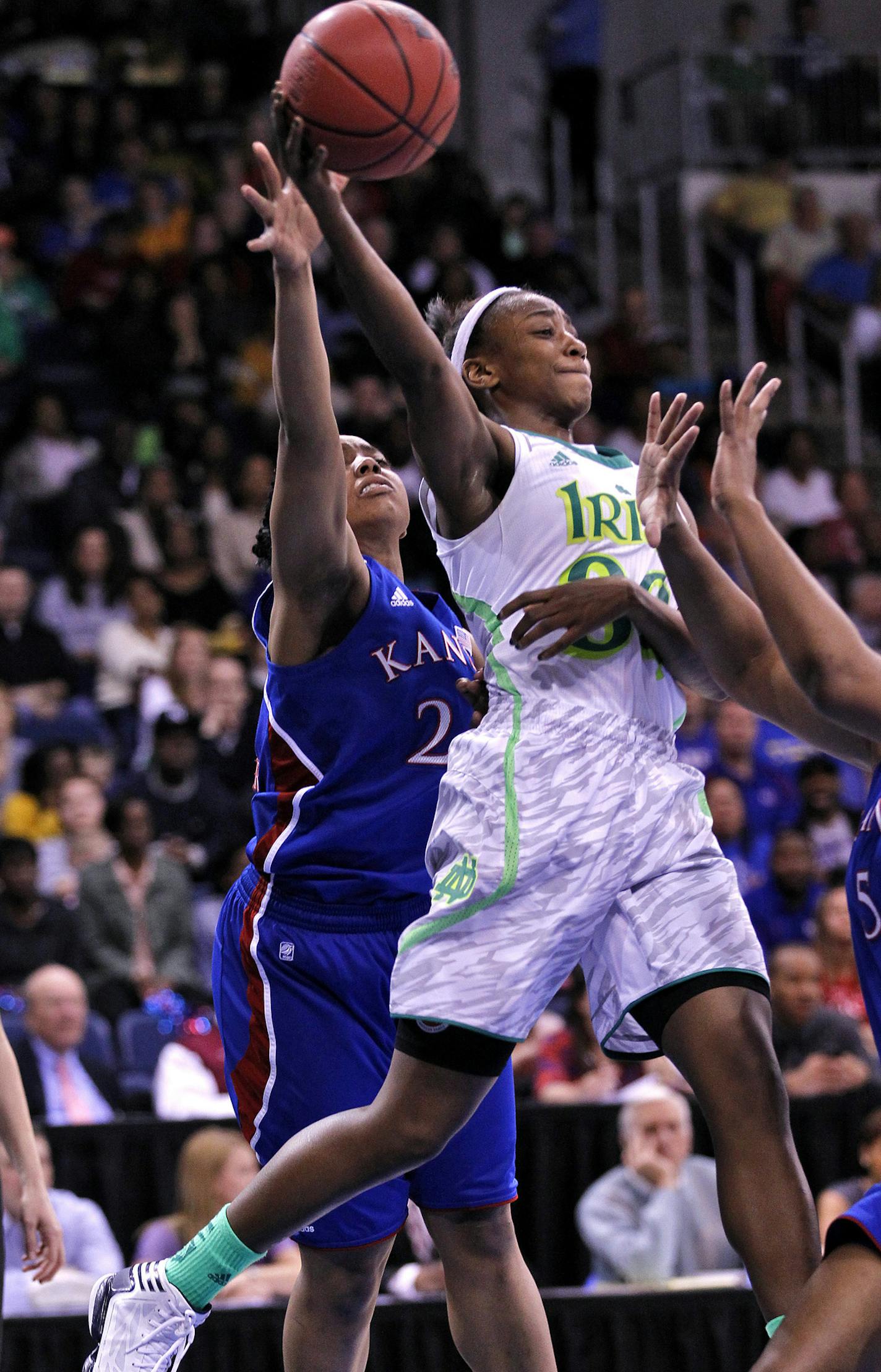 Notre Dame's Jewell Loyd, right, looks for a pass around Kansas' Cece Harper, left, during Sunday's NCAA women's basketball regional semifinal on March 31, 2013, at the Ted Constant Center in Norfolk, Virginia. (Jonathon Gruenke/Newport News Daily Press/MCT)