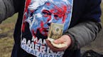 A vendor sells merchandise before a rally for Republican presidential candidate Donald Trump at Griffiss International Airport in Rome, N.Y., Tuesday,