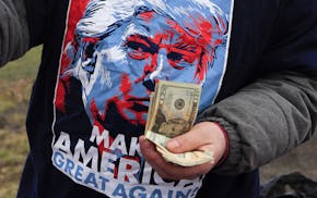A vendor sells merchandise before a rally for Republican presidential candidate Donald Trump at Griffiss International Airport in Rome, N.Y., Tuesday,