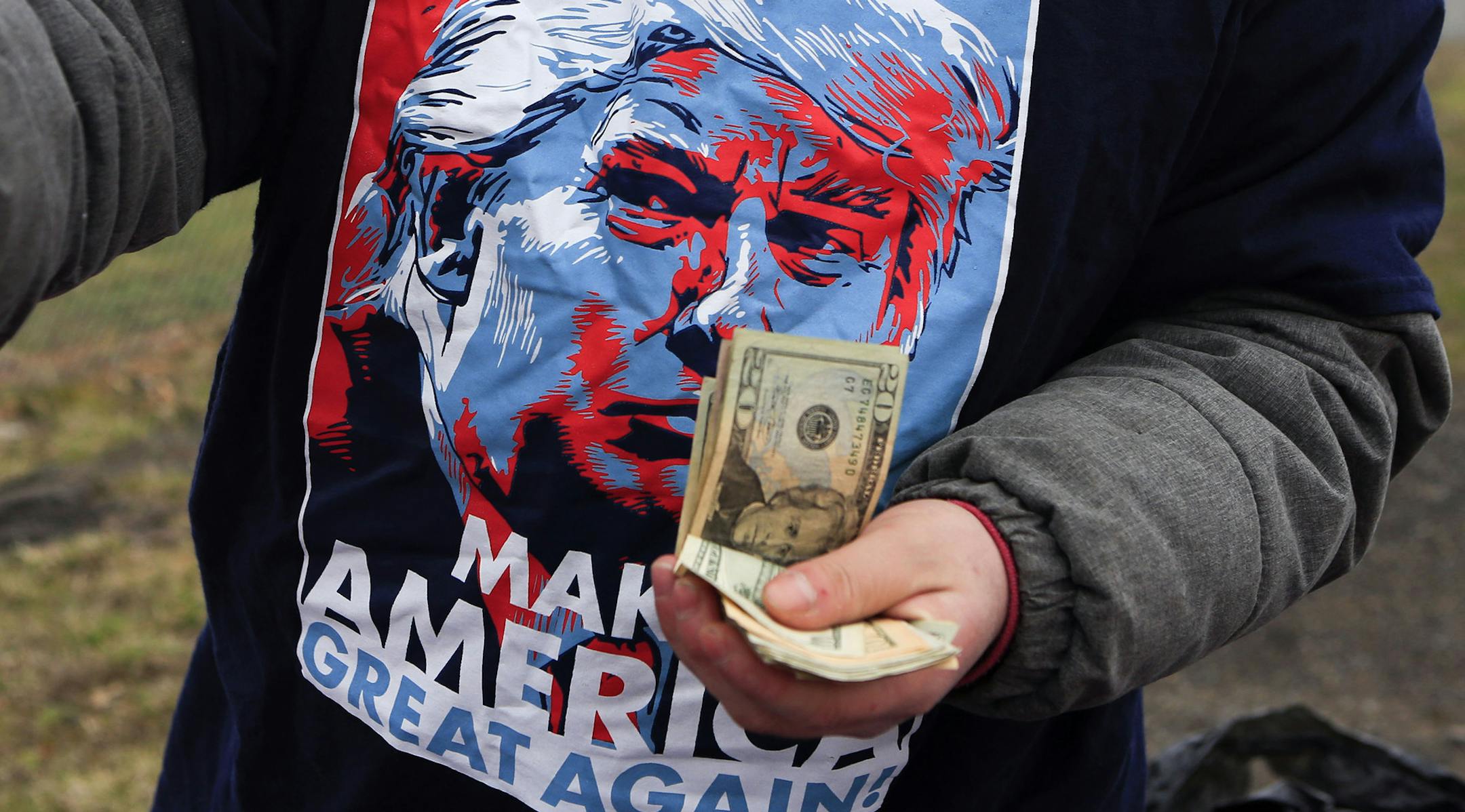 A vendor sells merchandise before a rally for Republican presidential candidate Donald Trump at Griffiss International Airport in Rome, N.Y., Tuesday, April 12, 2016. (AP Photo/Mike Groll) ORG XMIT: MIN2016041412343768
