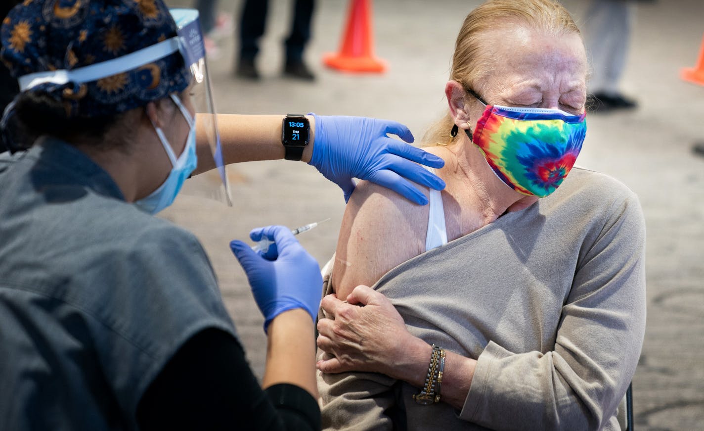 Susan Murr of South St. Paul closed her eyes in anticipation of her COVID vaccine from RN Darcey McCampbell.