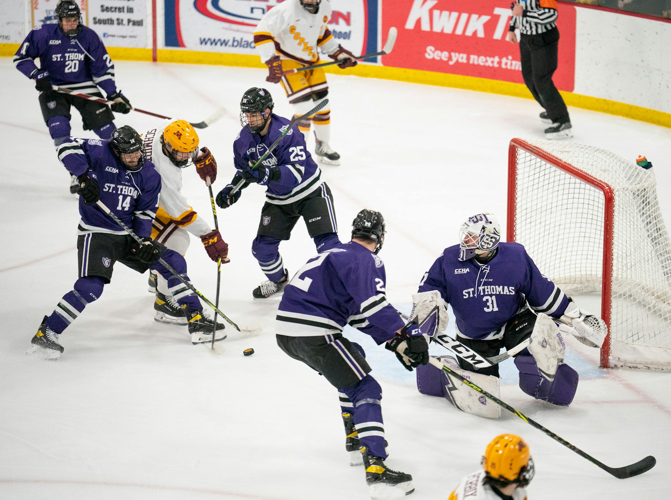Tommies defenseman Shayne Monahan (14) did his best to defend against the scoring shot of Gophers forward Colin Schmidt (16) on Tommies goaltender Jacob Berger (31) in the first period Sunday afternoon, Jan. 2, 2022 Friday, Dec. 17, 2021 at Doug Woog Arena in South St. Paul.