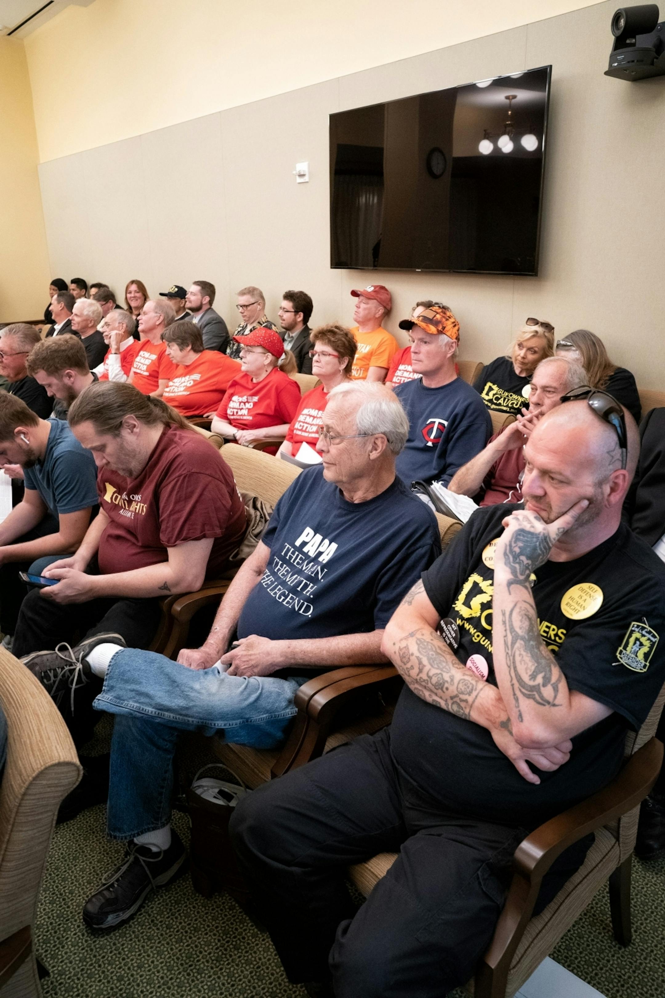 Rep. Dave Pinto, D-St. Paul, listened while Rob Doar of the Minnesota Gun Owners Caucus spoke against his bill in the Public Safety conference committee that was packed by advocates of both sides.