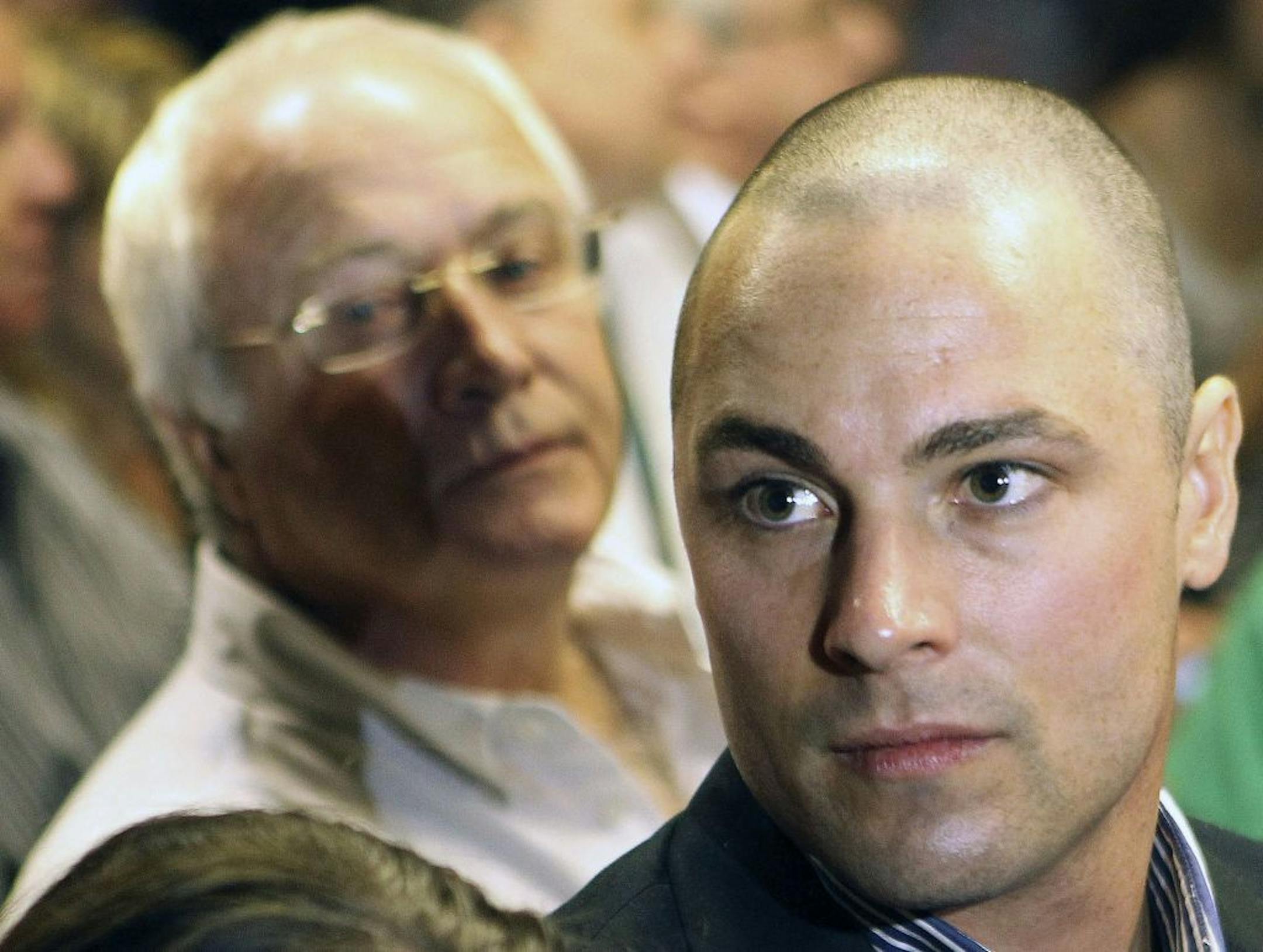 FILE - In this Feb. 19, 2013 file photo, Carl Pistorius, right, and Henke Pistorius, the brother and father of Olympic athlete Oscar Pistorius, charged with the shooting death of his girlfriend attend Oscar's bail hearing at the magistrate court in Pretoria, South Africa.
