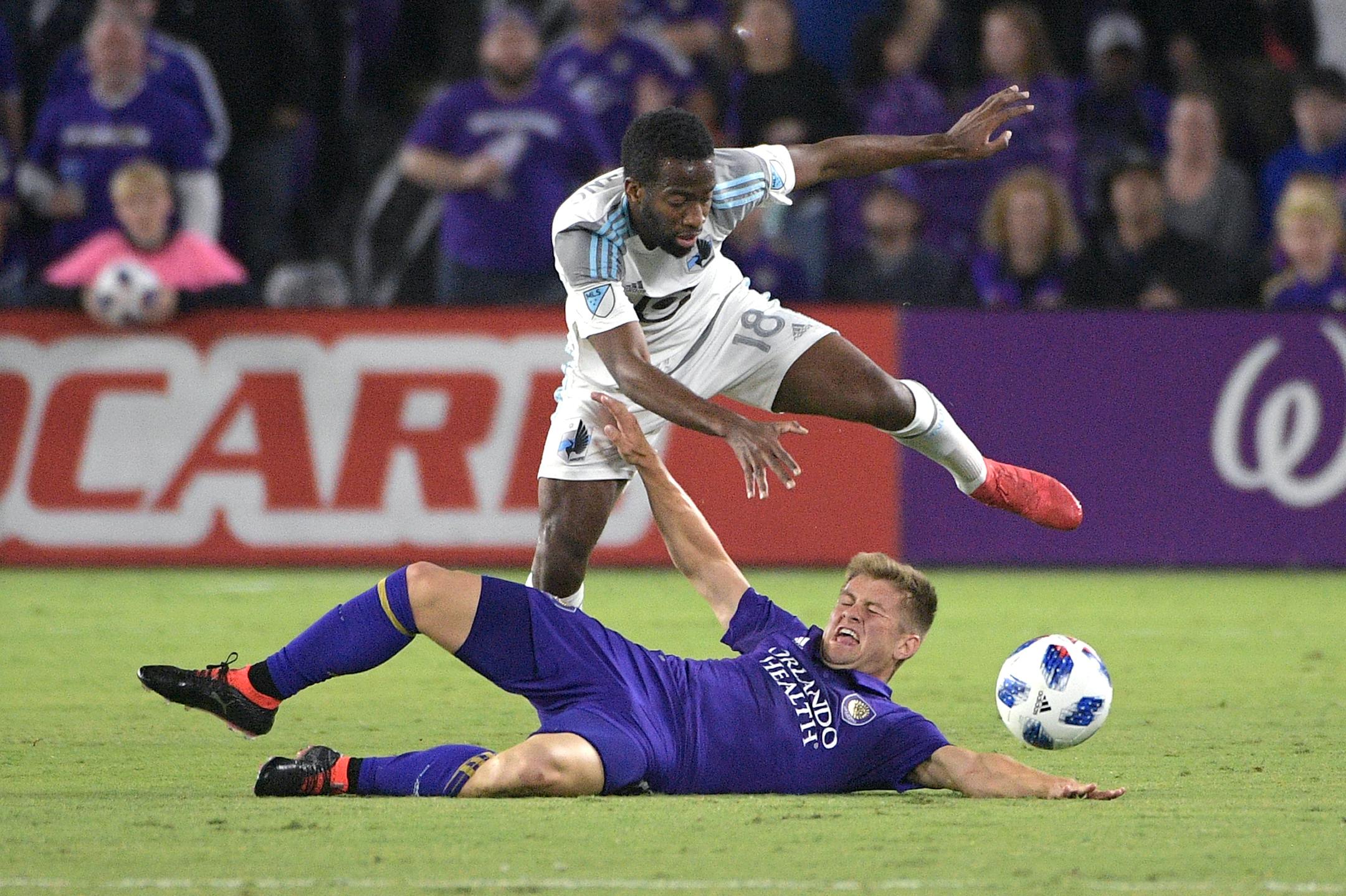 Orlando City midfielder Cameron Lindley (15) and Minnesota United midfielder Kevin Molino (18) battle for the ball during the first half of an MLS soccer match Saturday, March 10, 2018, in Orlando, Fla. Minnesota won 2-1. (Phelan M. Ebenhack for the Star-Tribune) ORG XMIT: OTKMINN120 ORG XMIT: MIN1803102124537421