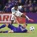 Orlando City midfielder Cameron Lindley (15) and Minnesota United midfielder Kevin Molino (18) battle for the ball during the first half of an MLS soc
