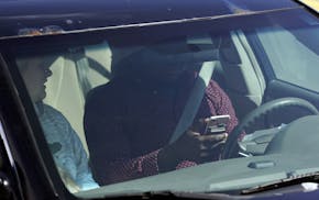 This April 24, 2019 photo shows one of several distracted drivers using a cell phones and spotted by Eagan, Minn., police officers during the "Busted