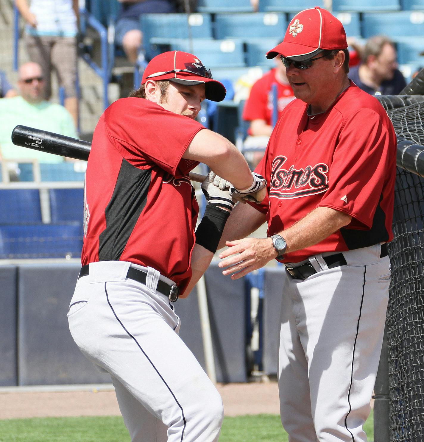 Houston Astros infielder Mike Kvasnicka gets help from Astros hitting coach Mike Barnett, right, prior to a spring baseball game between the Astros and New York Yankees, Wednesday March 2, 2011, in Tampa, Fla. (AP Photo/Margaret Bowles) ORG XMIT: FLMB101