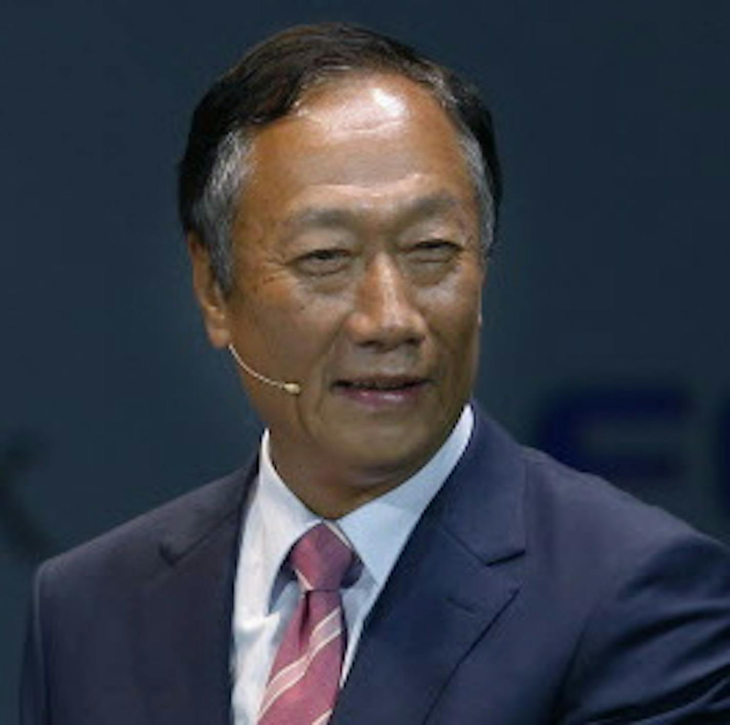 Softbank Corp. CEO Masayoshi Son, center, Alibaba Group Executive Chairman Jack Ma, left, of China and Foxconn Chairman and CEO Terry Gou of Taiwan pose for photographers with Softbank's Pepper robot during a press conference in Maihama, near Tokyo, Thursday, June 18, 2015. Son said the company was preparing for a global sales launch with partners Alibaba Group and FoxConn. They will each take a 20 percent stake in Softbank's robotics unit, and help with software and manufacturing. (AP Photo/Shi