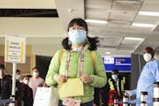 Passengers arriving from a China Southern Airlines flight from Changsha in China are screened for the new type of coronavirus, whose symptoms are simi