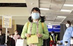 Passengers arriving from a China Southern Airlines flight from Changsha in China are screened for the new type of coronavirus, whose symptoms are simi