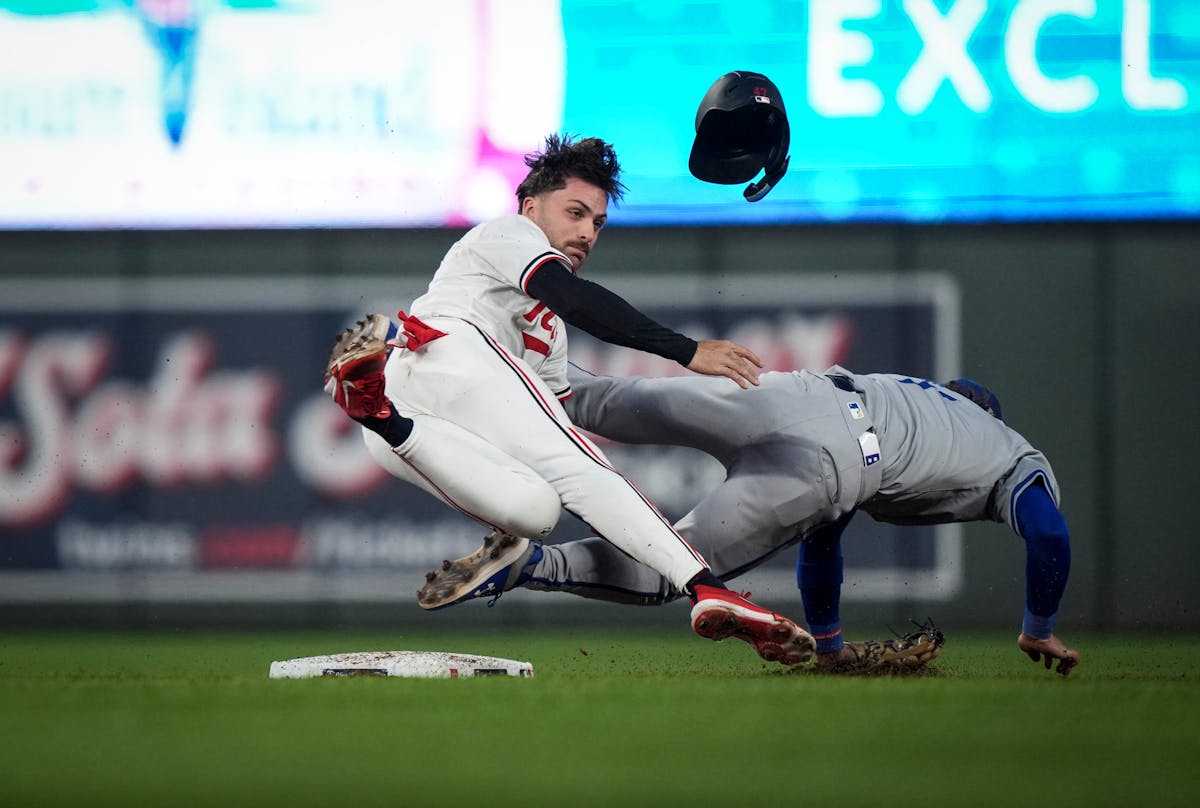 The Twins' Edouard Julien, left, collides with Royals shortstop Bobby Witt Jr. while stealing second in the bottom of the eighth inning. 
