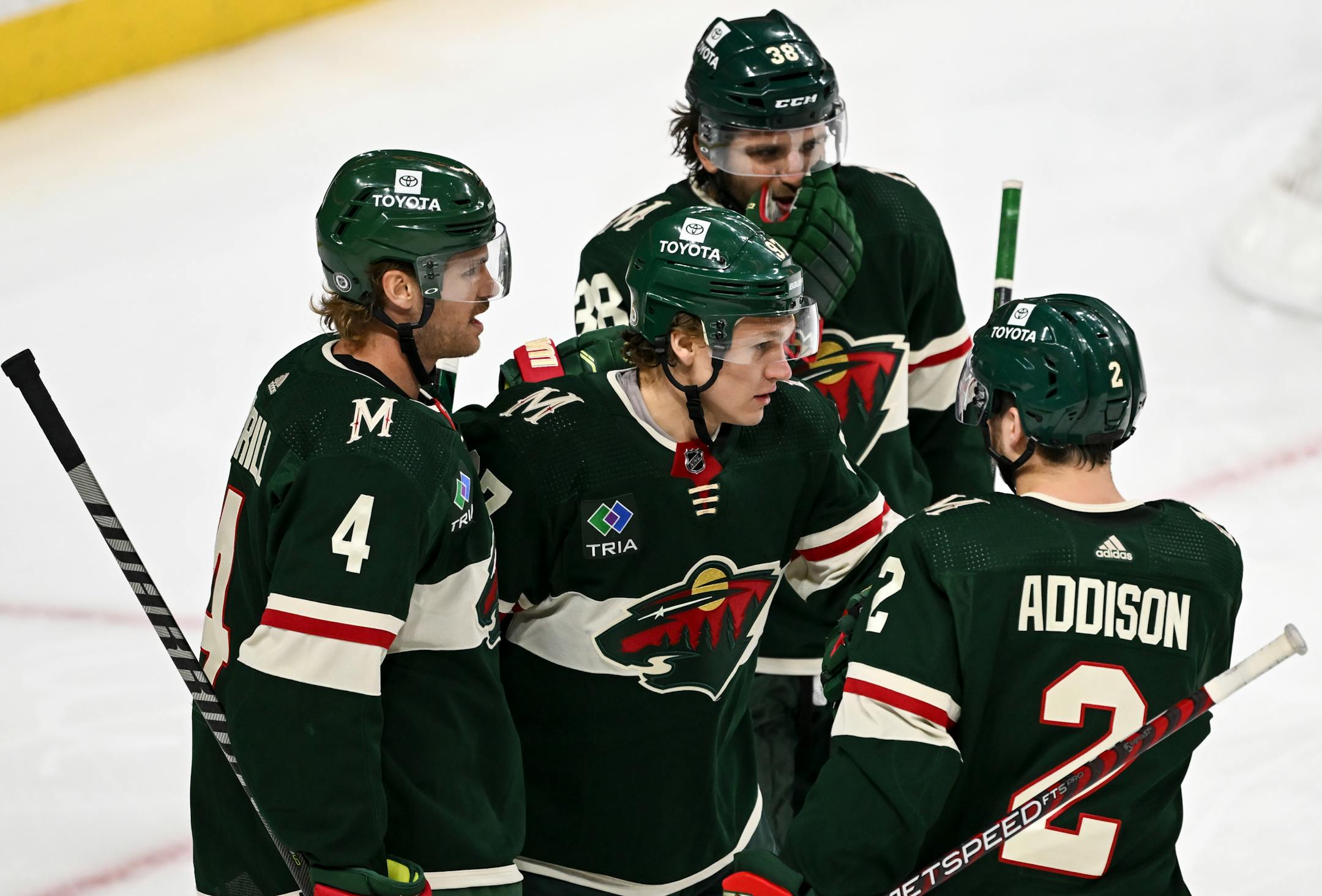 Minnesota Wild defenseman Jon Merrill (4), left wing Kirill Kaprizov (97), right wing Ryan Hartman (38) and defenseman Calen Addison (2) celebrate a goal by Kaprizov during the second period.