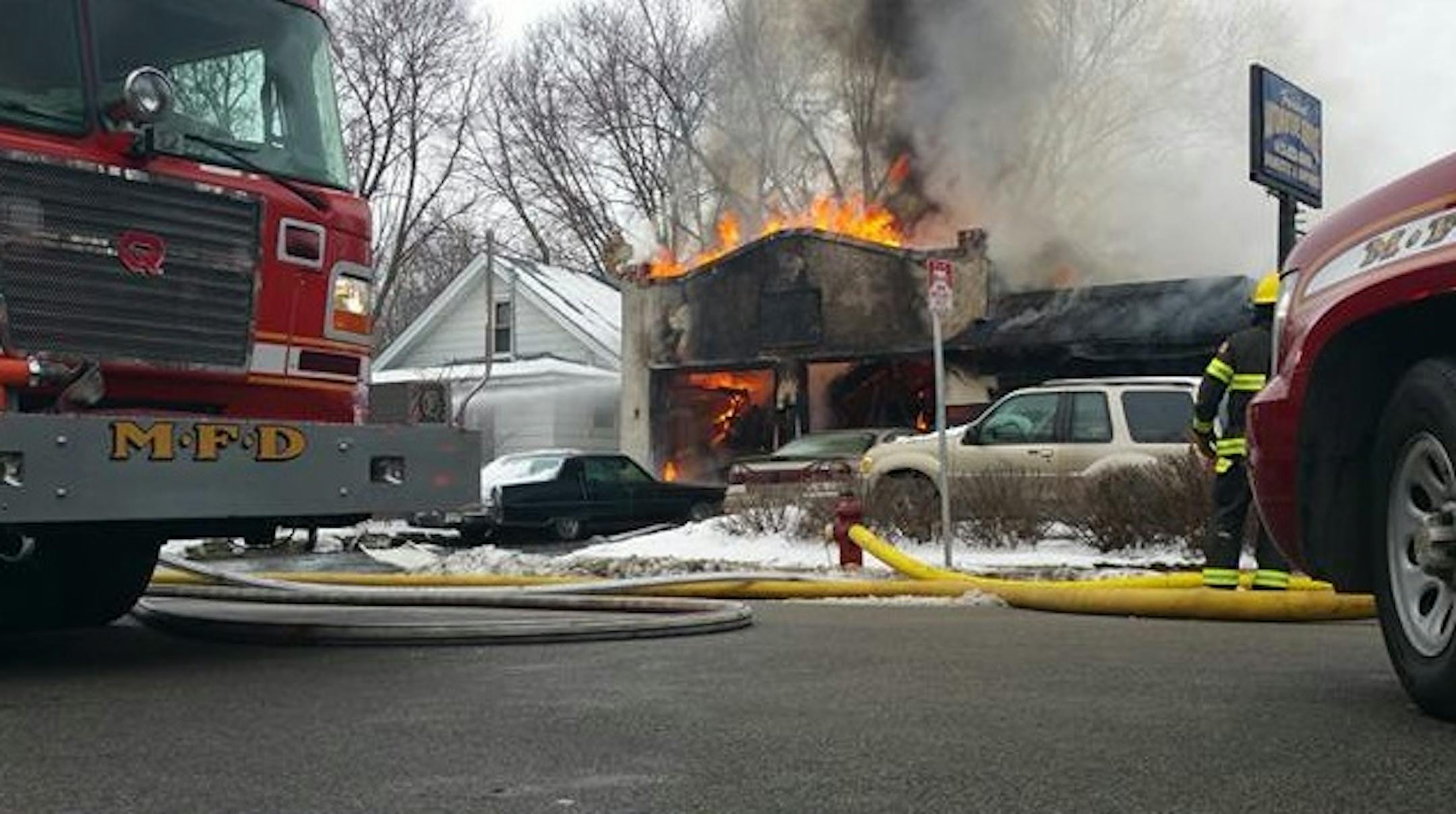 A small auto body shop was engulfed in flames in a residential street corner in north Minneapolis.