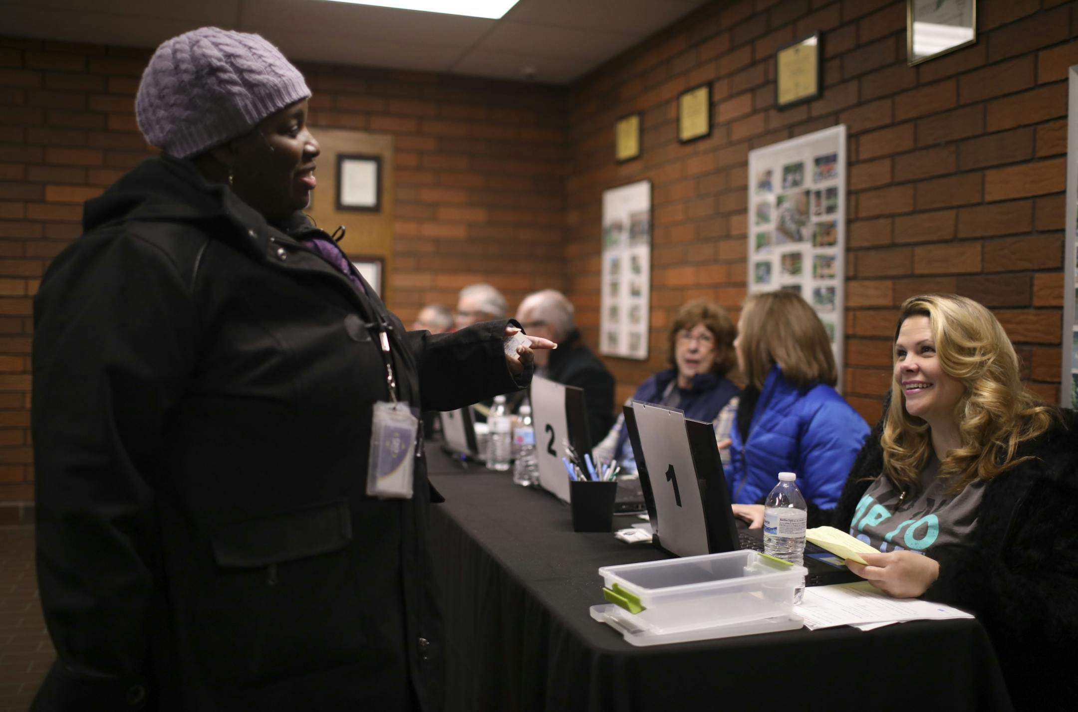 Christy Vasquez, right, recognized her neighbor, Bobbie Asubonteng, as she was getting her checked in to pick up her Thanksgiving grocery bag Monday evening.