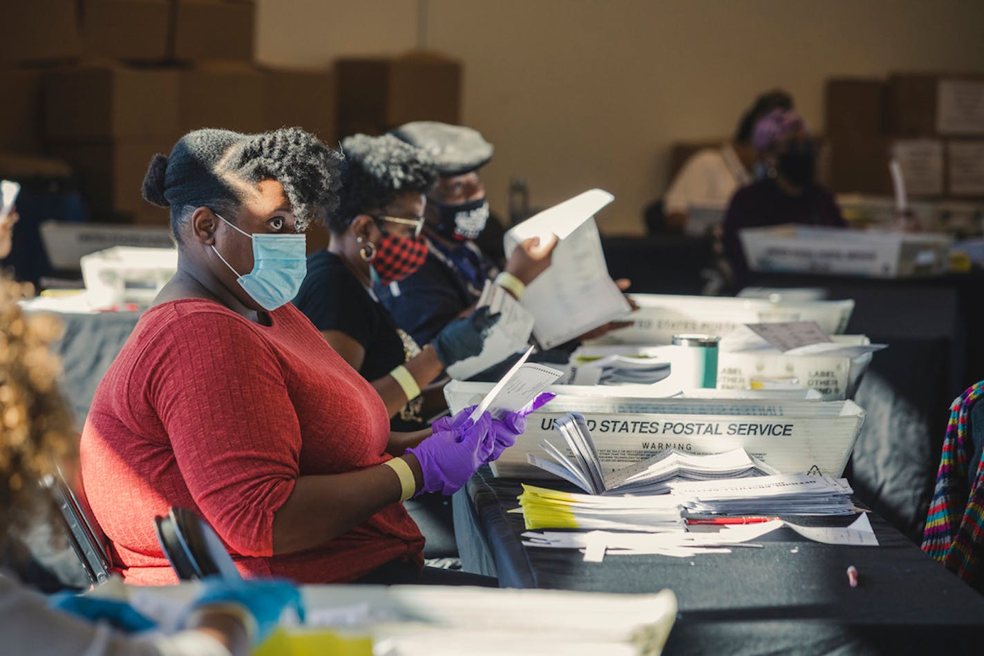 Election workers process absentee ballots at State Farm Arena in Atlanta, Nov. 4, 2020.