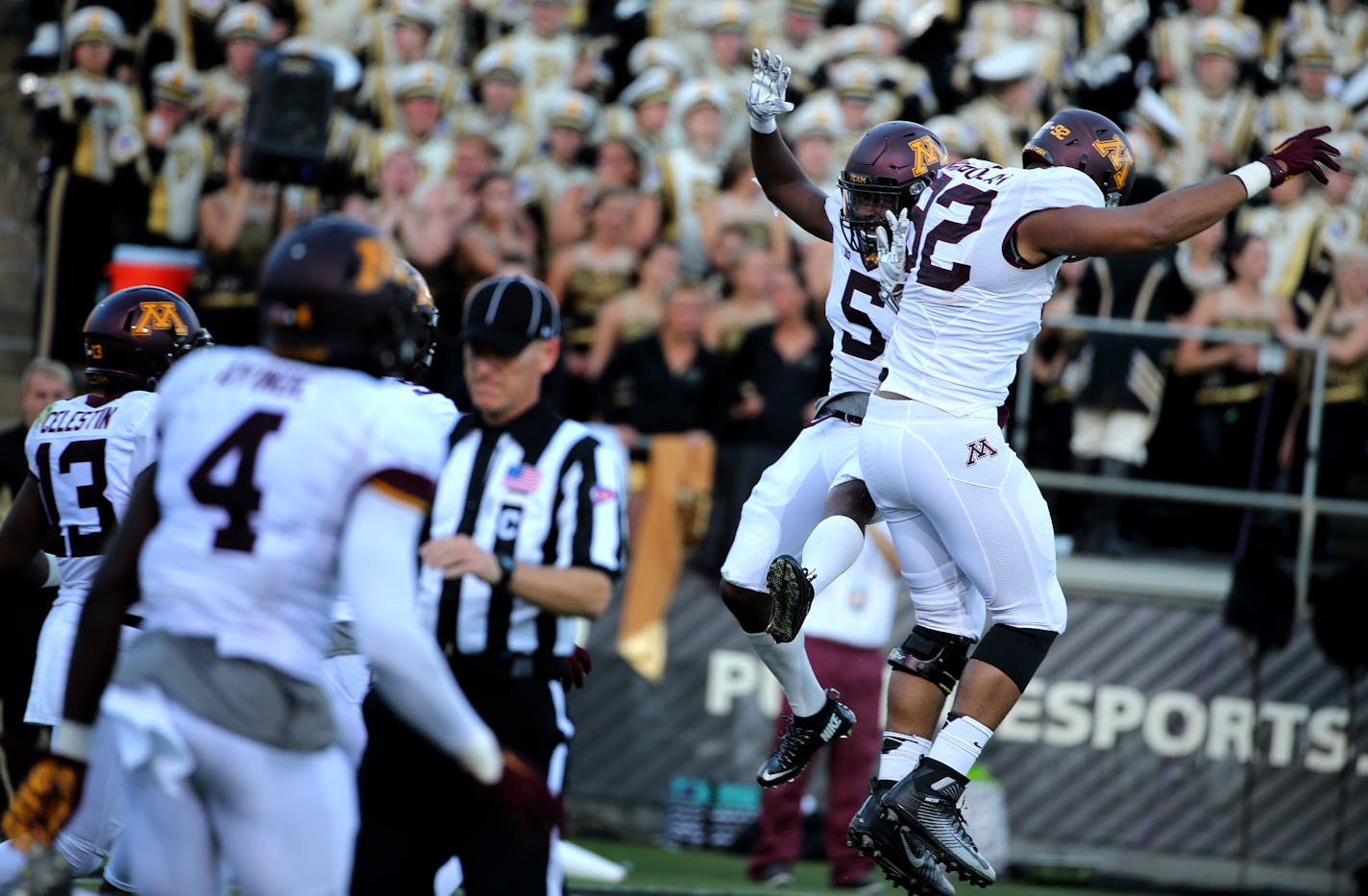 Robert Ndondo-Lay (92) celebrated with Minnesota defensive back Jalen Myrick (5) after Myrick returned an interception for a touchdown during third quarter.