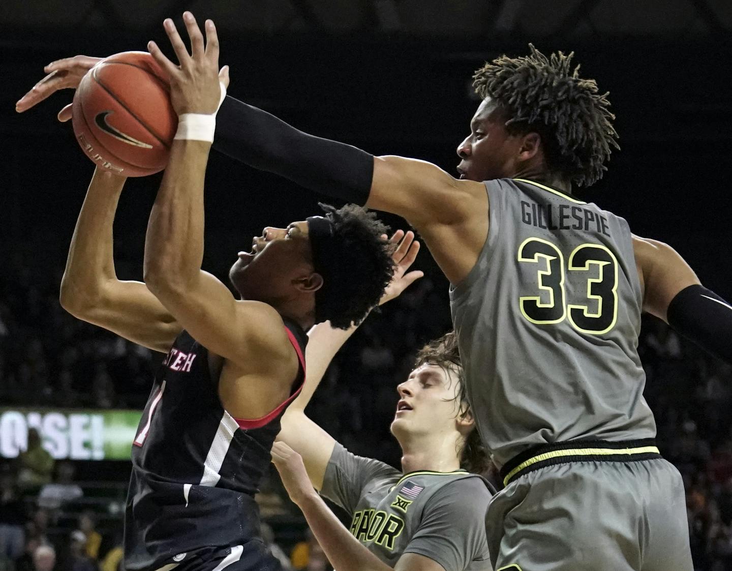 Baylor's Freddie Gillespie (33) blocks a shot by Texas Tech's Terrence Shannon Jr. (1) during the second half of an NCAA college basketball game in Waco, Texas, Monday, March 2, 2020. (AP Photo/Chuck Burton)