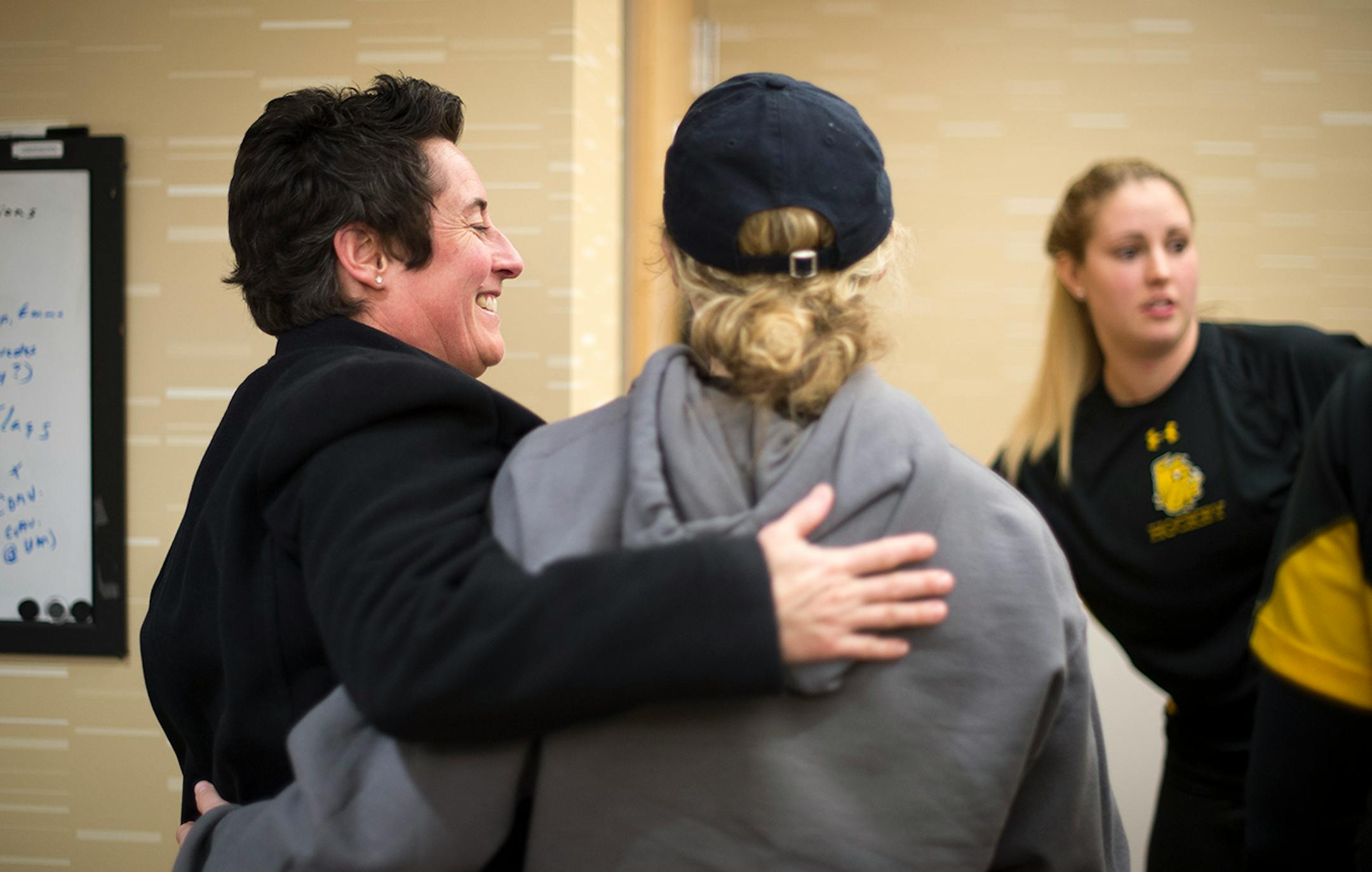 University of Minnesota Duluth womens' hockey head coach Shannon Miller hugs forward Zoe Hickel as Emma Stauber opens the door to leave Millers's office after a captain's meeting on Saturday night. ] (Aaron Lavinsky | StarTribune) University of Minnesota Duluth told women's hockey head coach Shannon Miller that this season would be the las of her successful run as the Bulldog's coach. After five national championships, an NCAA record, and 11 Frozen Four Victories, Miller, the highest-paid coach