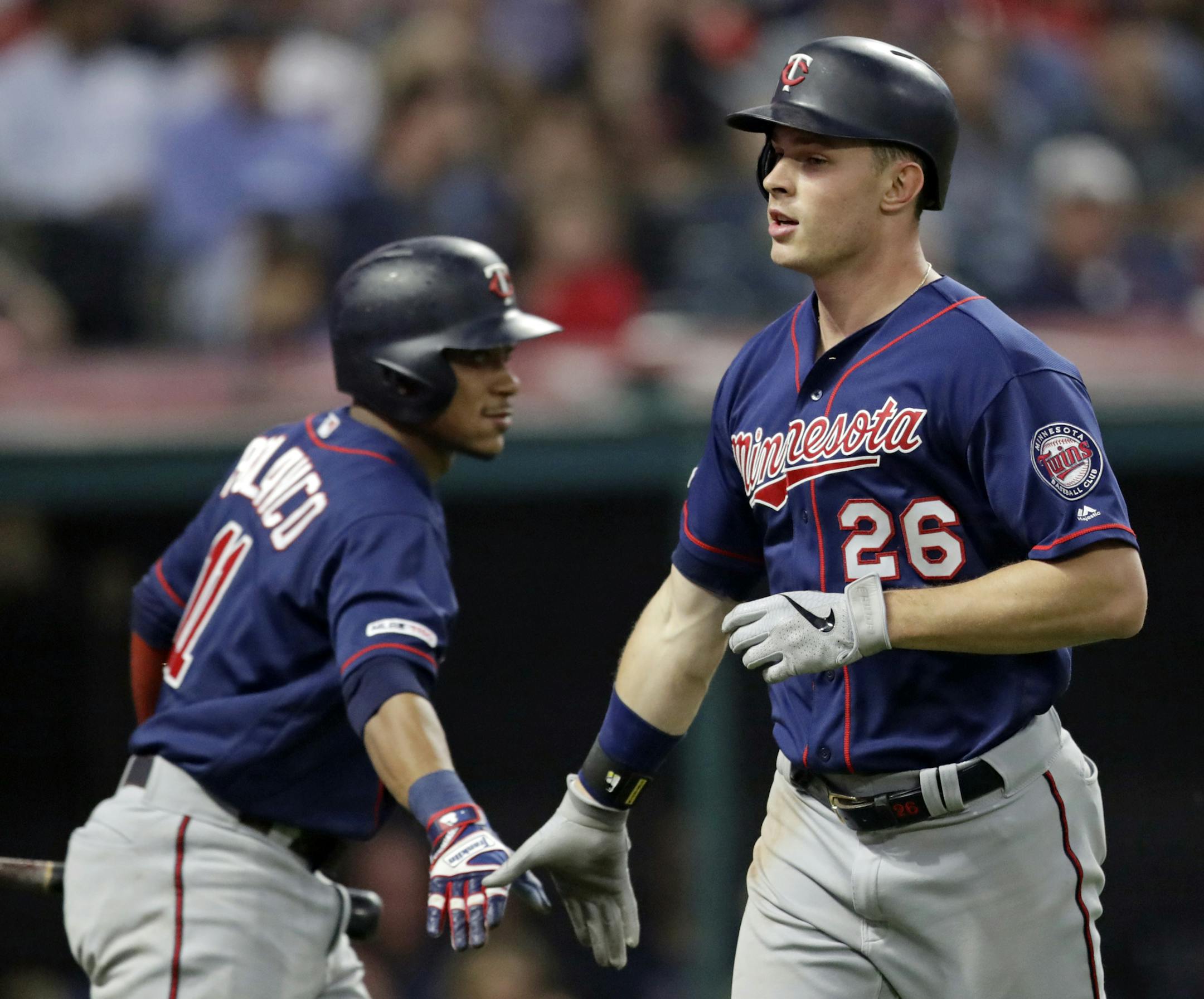 Minnesota Twins' Max Kepler, right, is congratulated by Jorge Polanco after Kepler hit a solo home run during the seventh inning of the team's baseball game against the Cleveland Indians, Thursday, June 6, 2019, in Cleveland. (AP Photo/Tony Dejak)