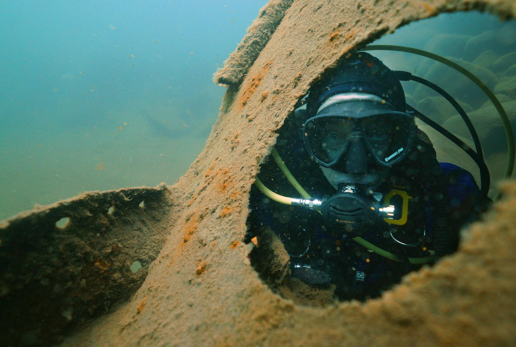 Jack Decker, a diver with the Great Lakes Shipwreck Preservation Society from Clear Lake, Iowa, peered through a hawse hole on the Madeira.