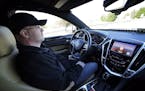 Virginia Tech Center for Technology Development's Greg Brown is behind the wheel of a driverless car during a test ride.